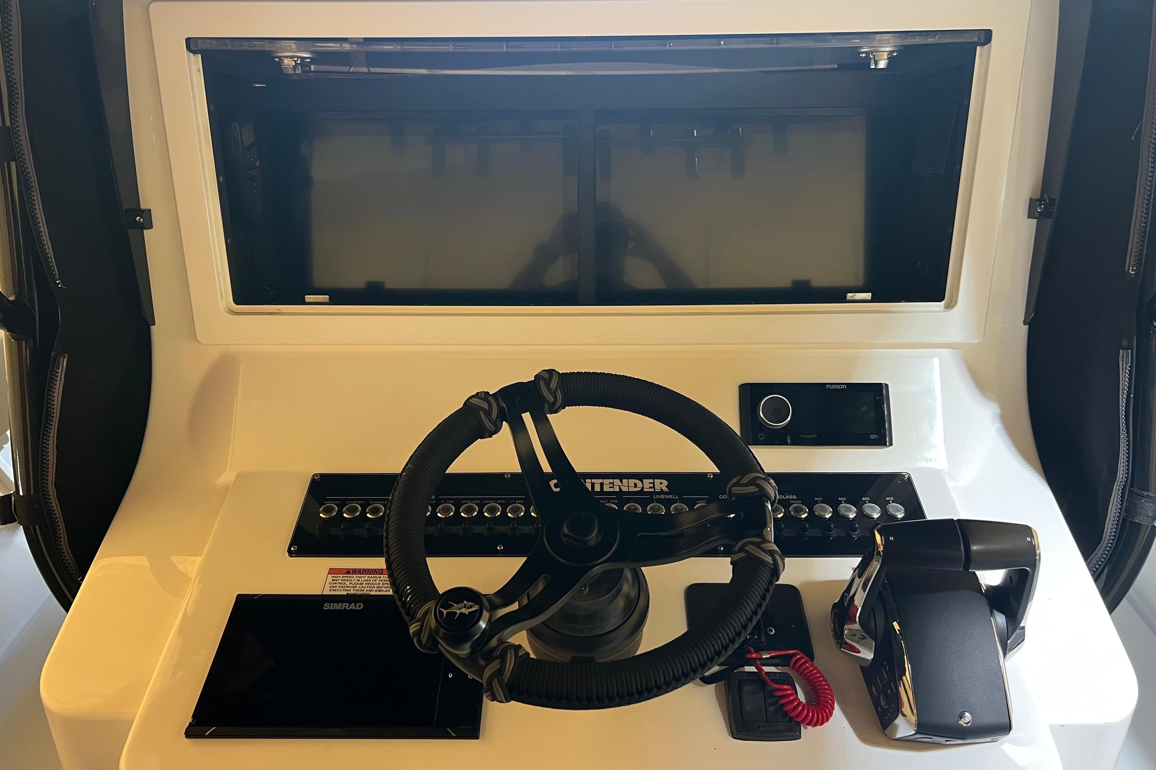 2018 Contender 39 ST boat dashboard with steering wheel and control panel.