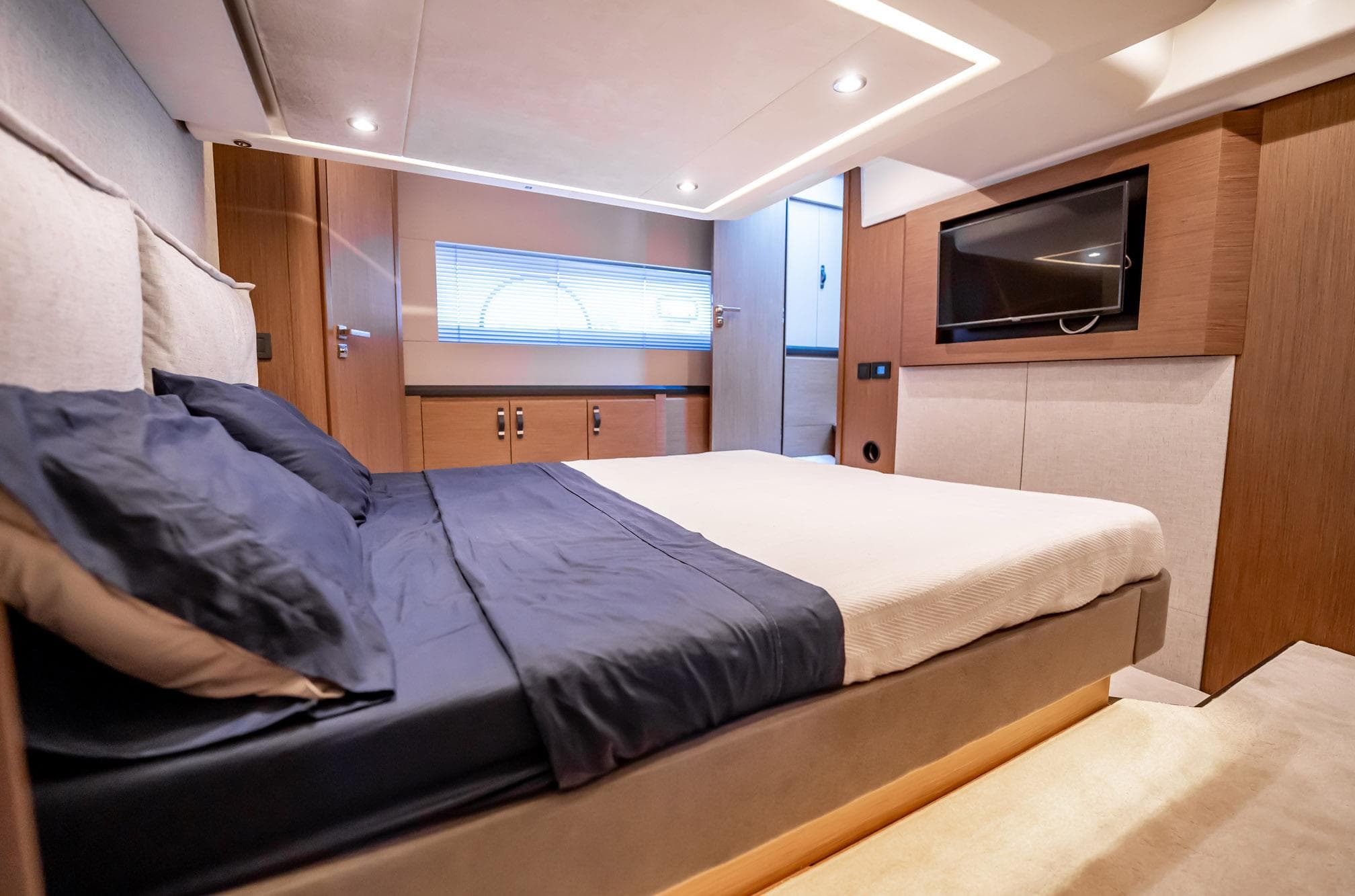 Luxurious bedroom interior of 2021 Beneteau Monte Carlo 52 yacht with modern design.