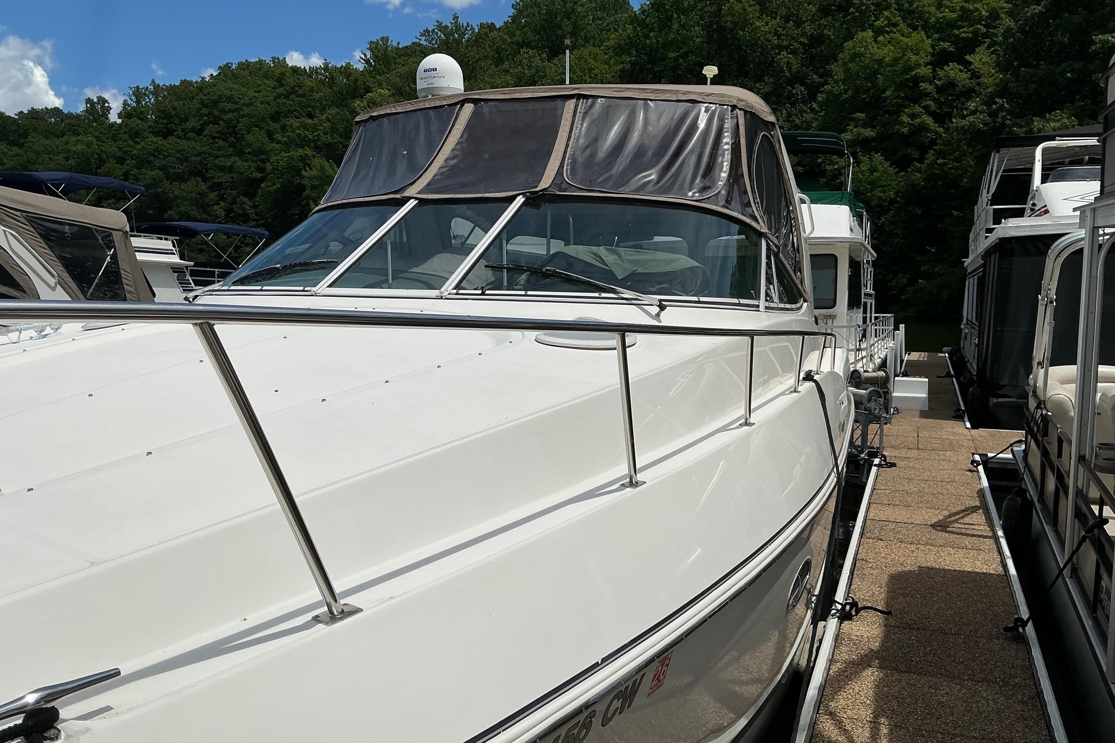 2005 Cruisers Yachts 370 Express docked, featuring sleek design and spacious deck.