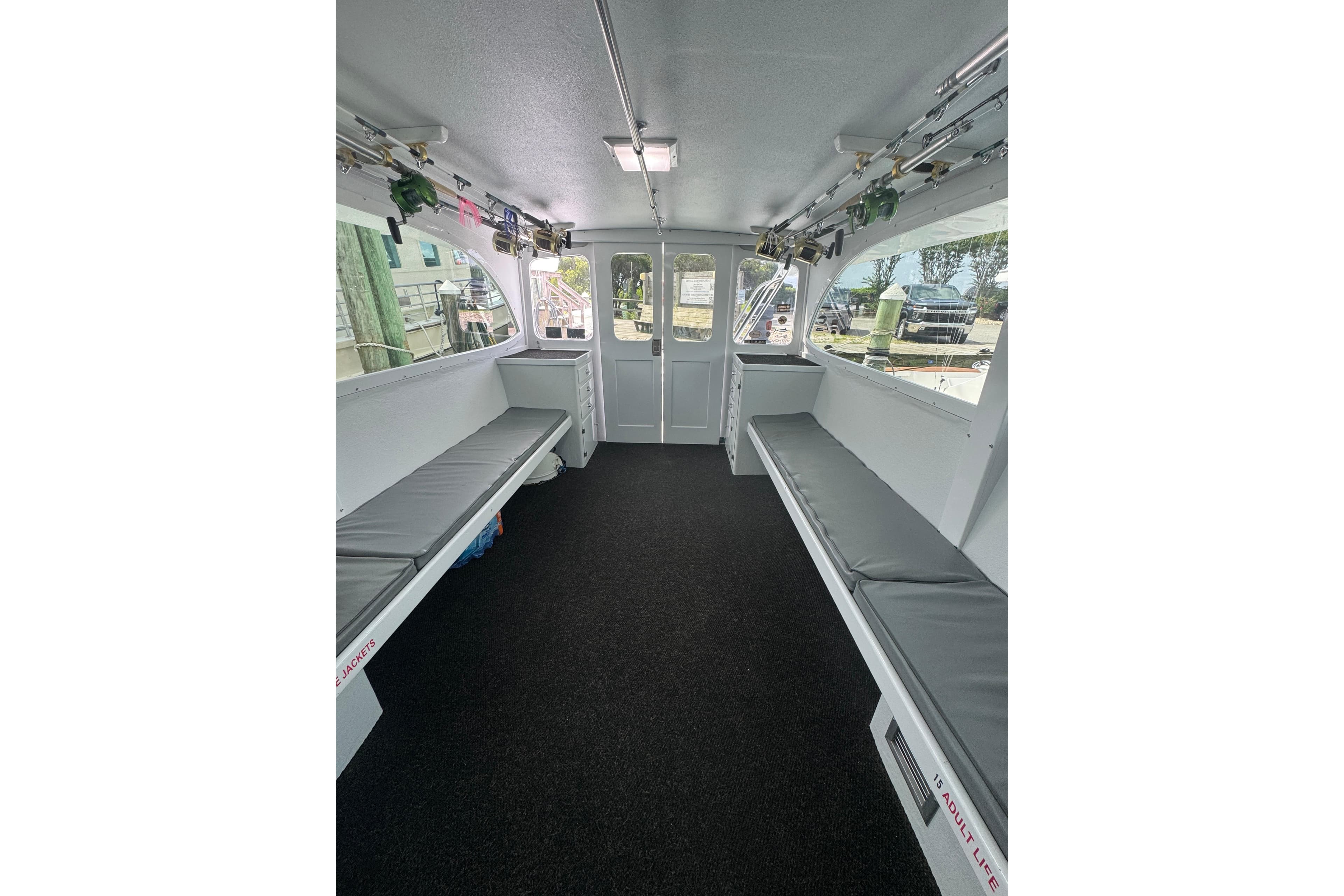 Interior of 1990 Buddy Cannady 57 Custom Carolina boat with seating and fishing rods.