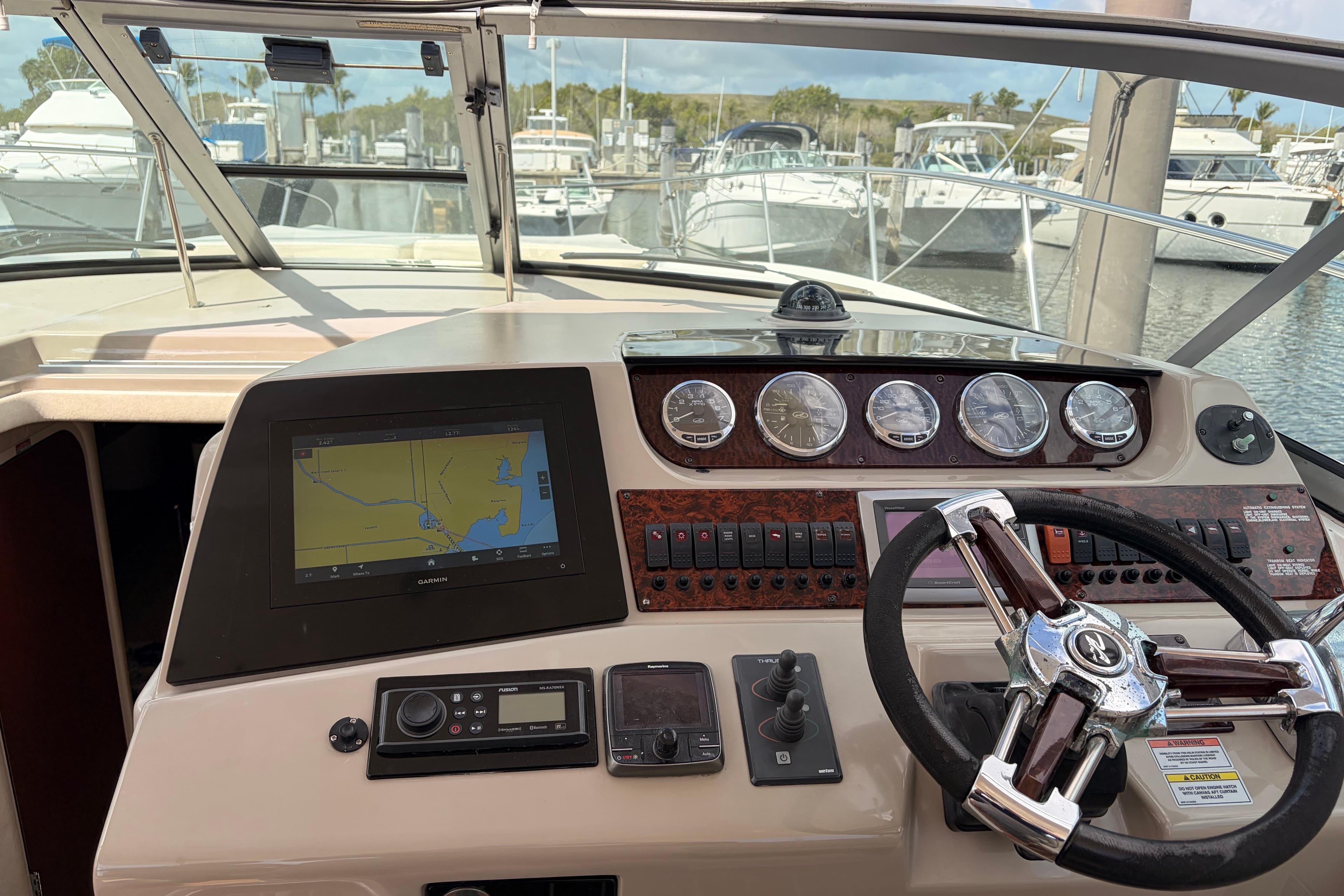 Cockpit of 2008 Sea Ray Sundancer 350 with navigation system and steering wheel.