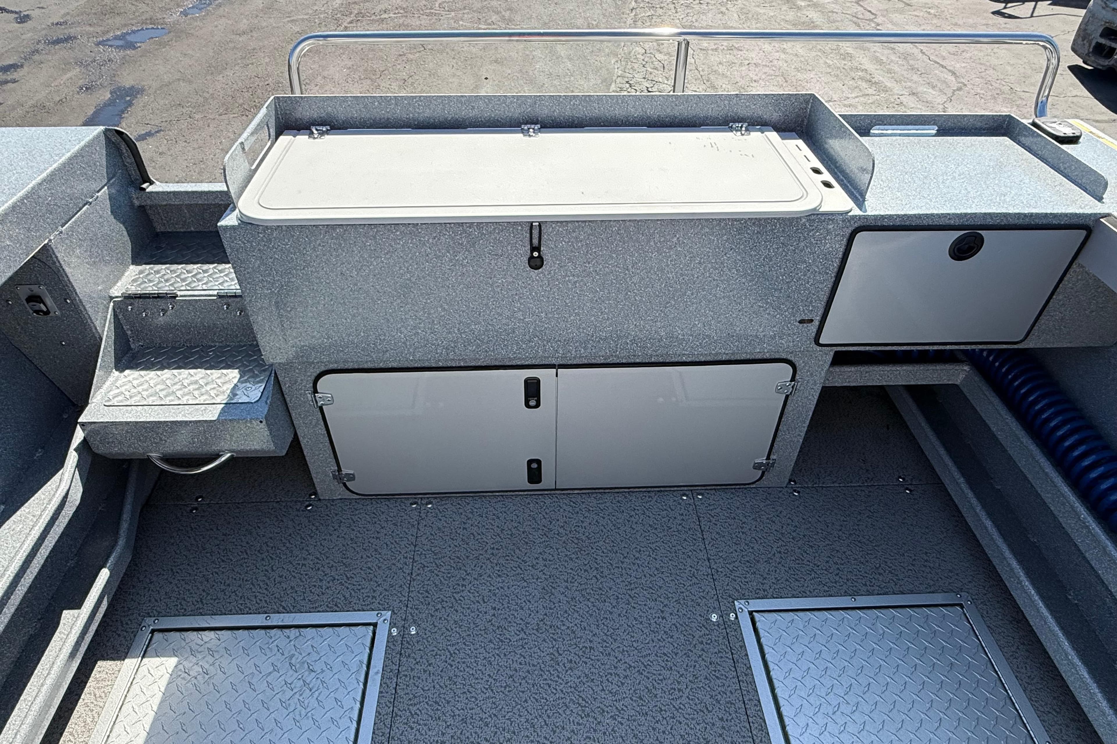 Interior of 2025 KingFisher 2225 Escape HT boat, featuring storage compartments and non-slip flooring.