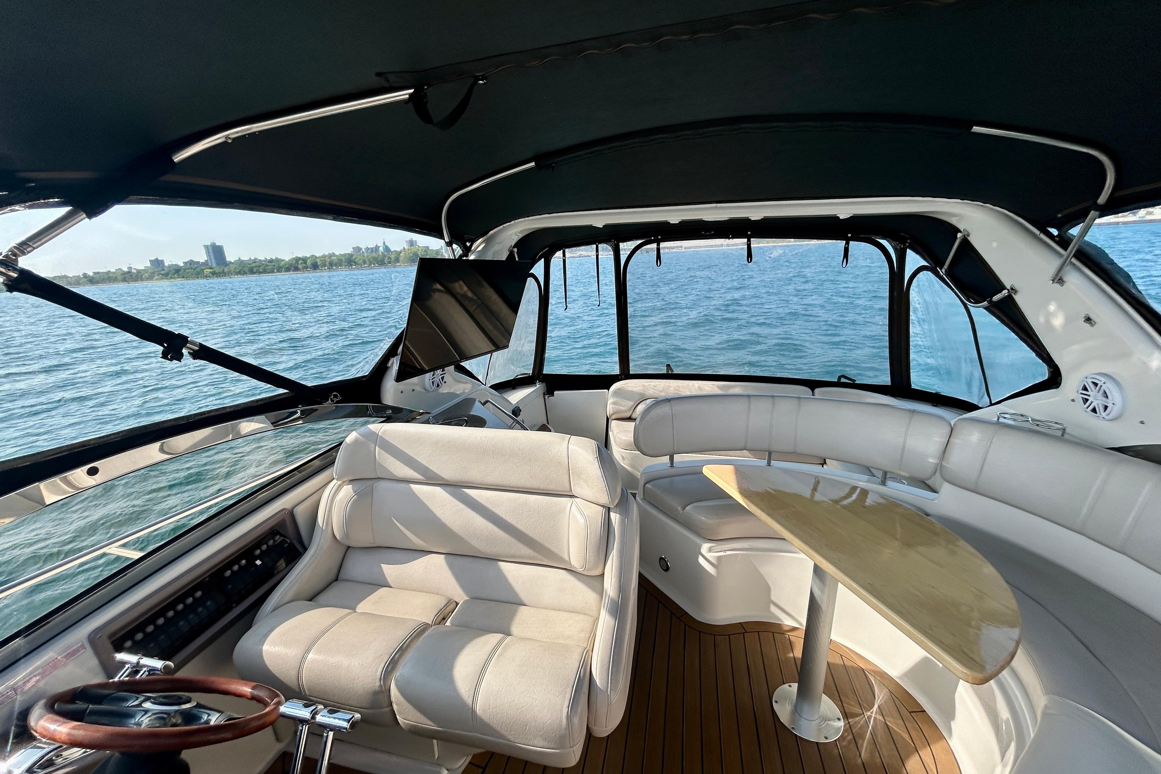 Interior of 2002 Regal Commodore 3860 yacht with seating and table on open water.
