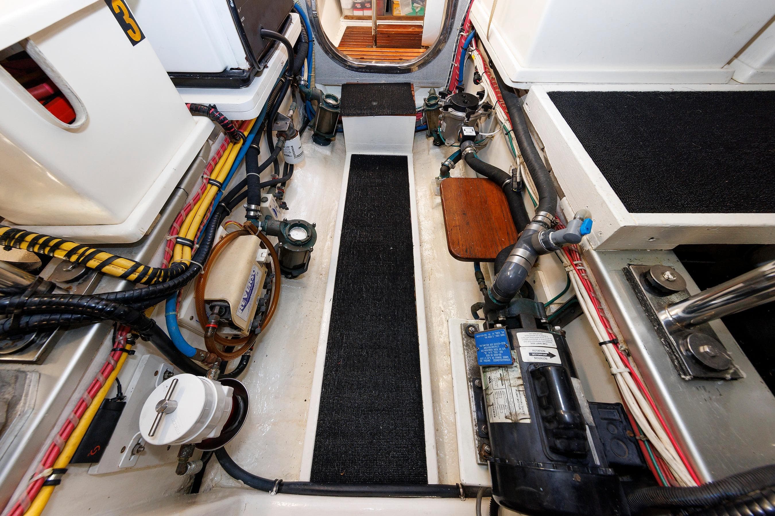 Engine room of 2007 Grand Banks 59 Aleutian RP yacht, showcasing mechanical components.