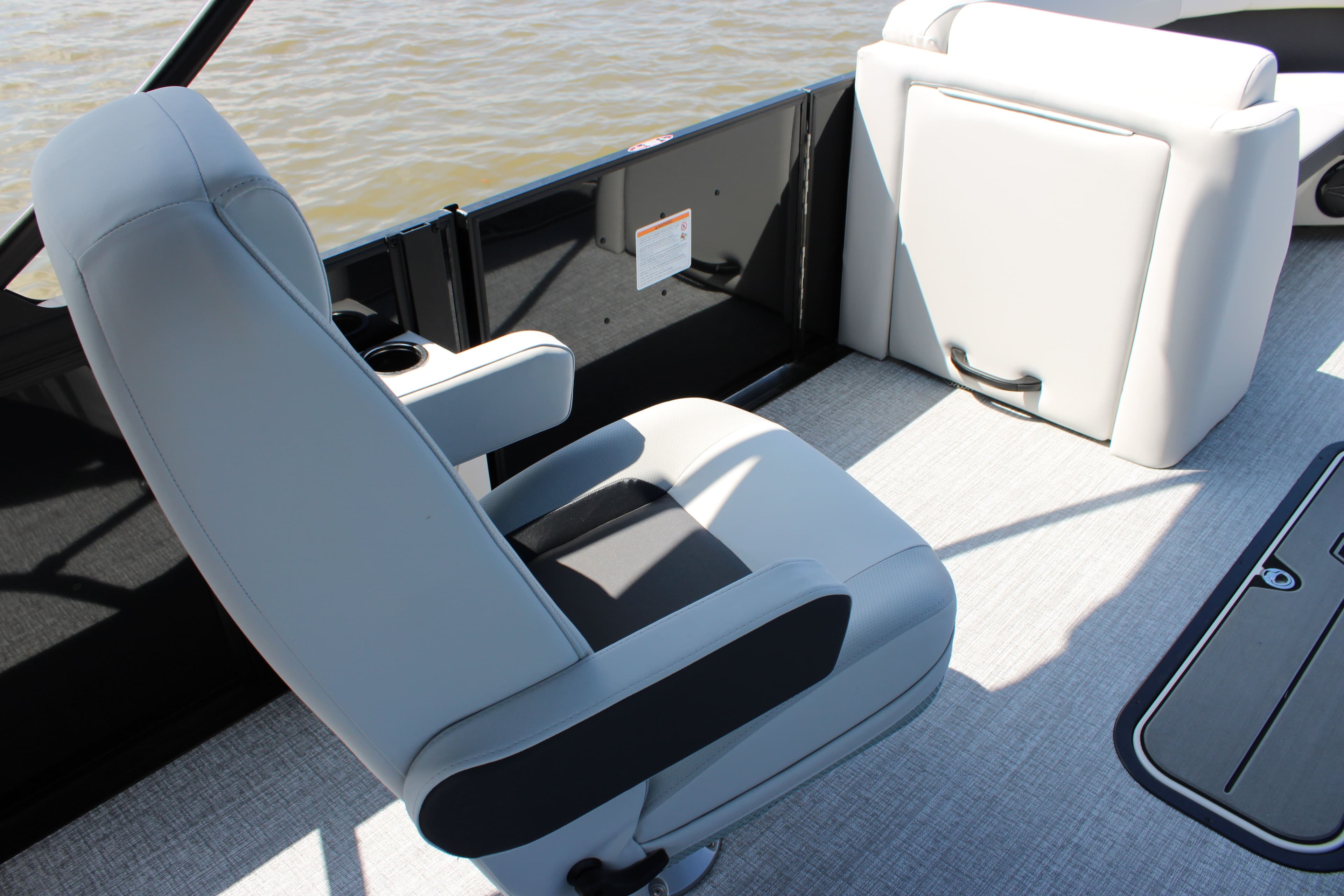 Interior of Harris Cruiser 230 boat, 2026 model, featuring gray seating.