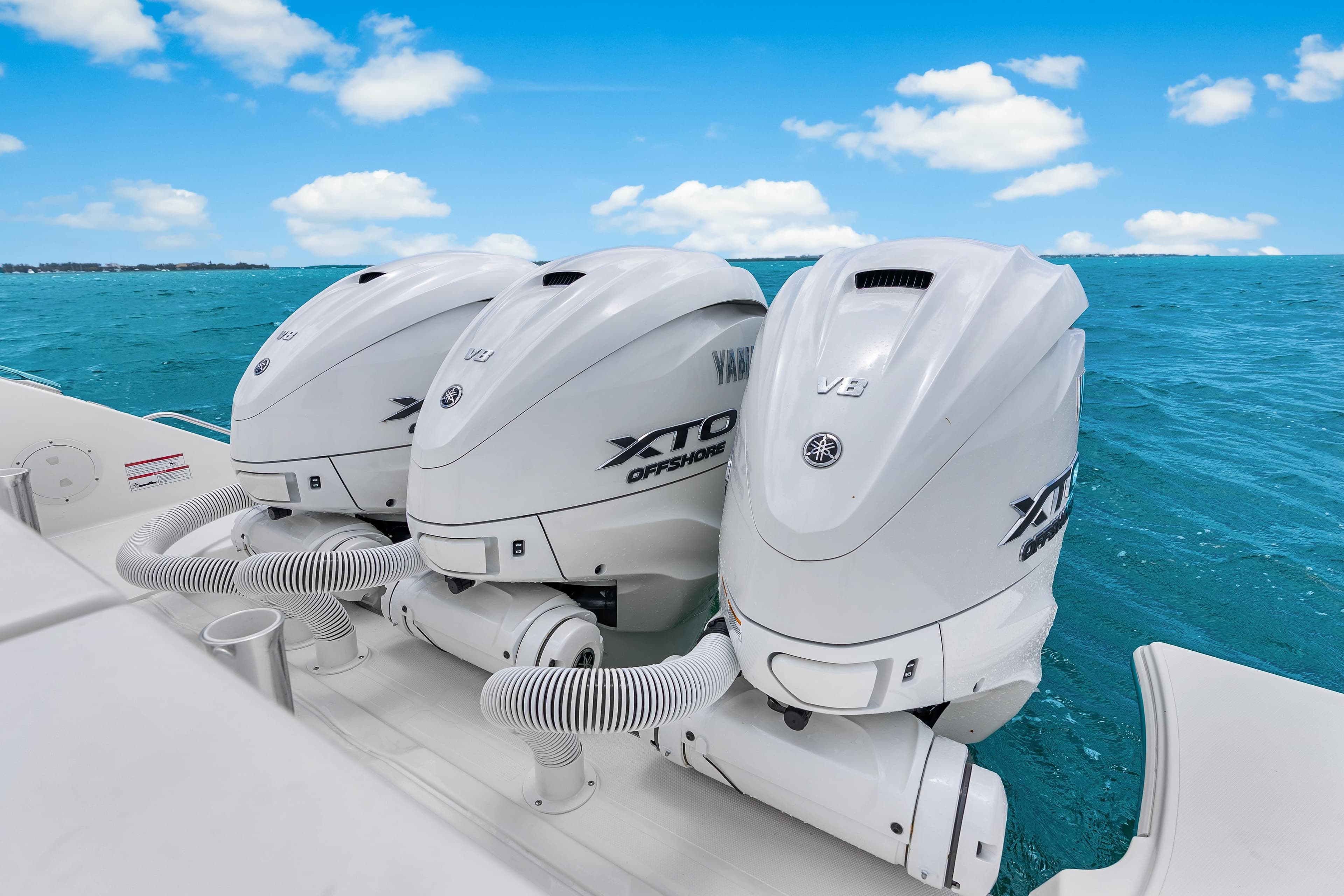 Triple Yamaha XTO Offshore engines on 2026 Pursuit OS 405 boat, ocean backdrop.