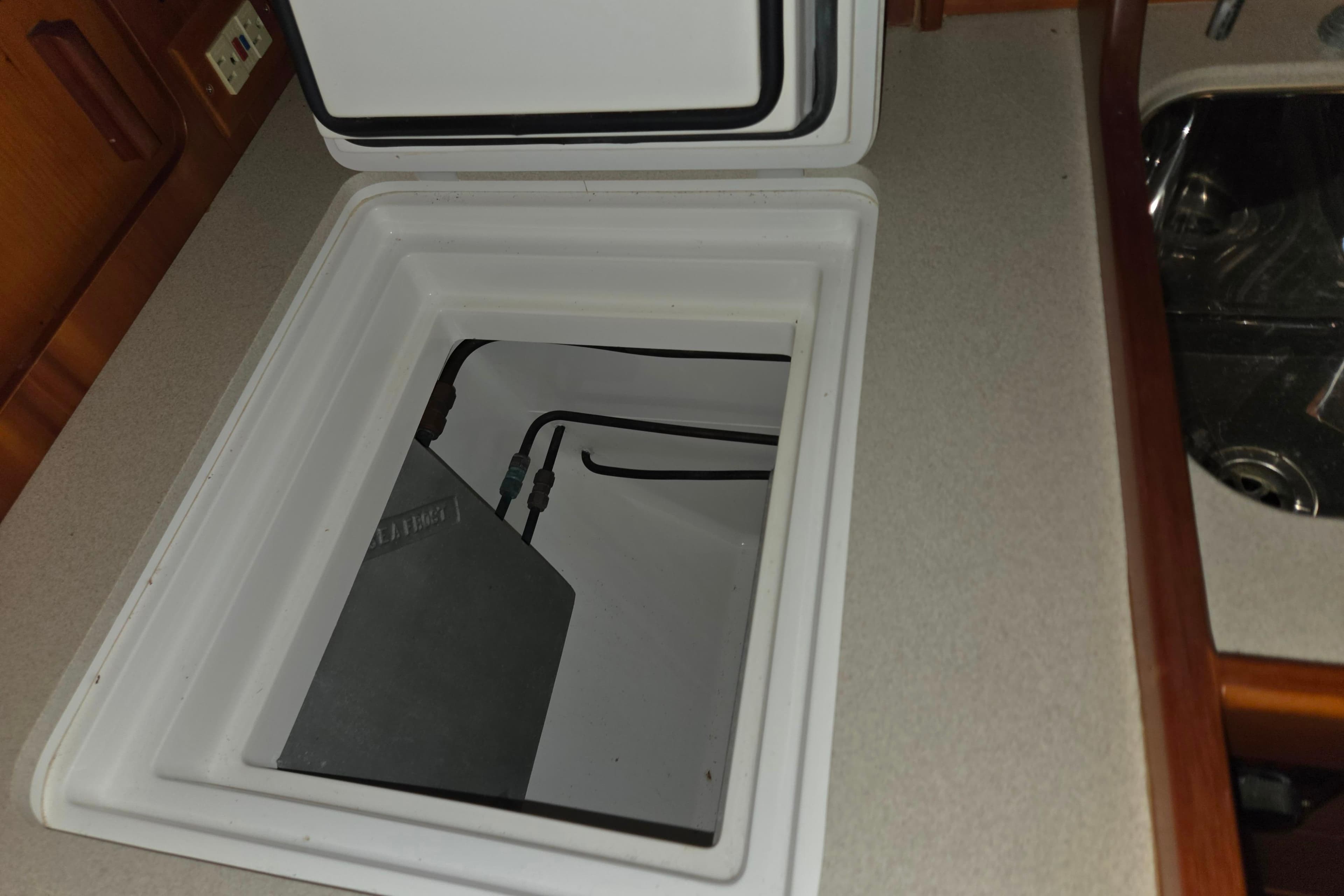 Open storage compartment in 2000 J Boats J/46 yacht galley.