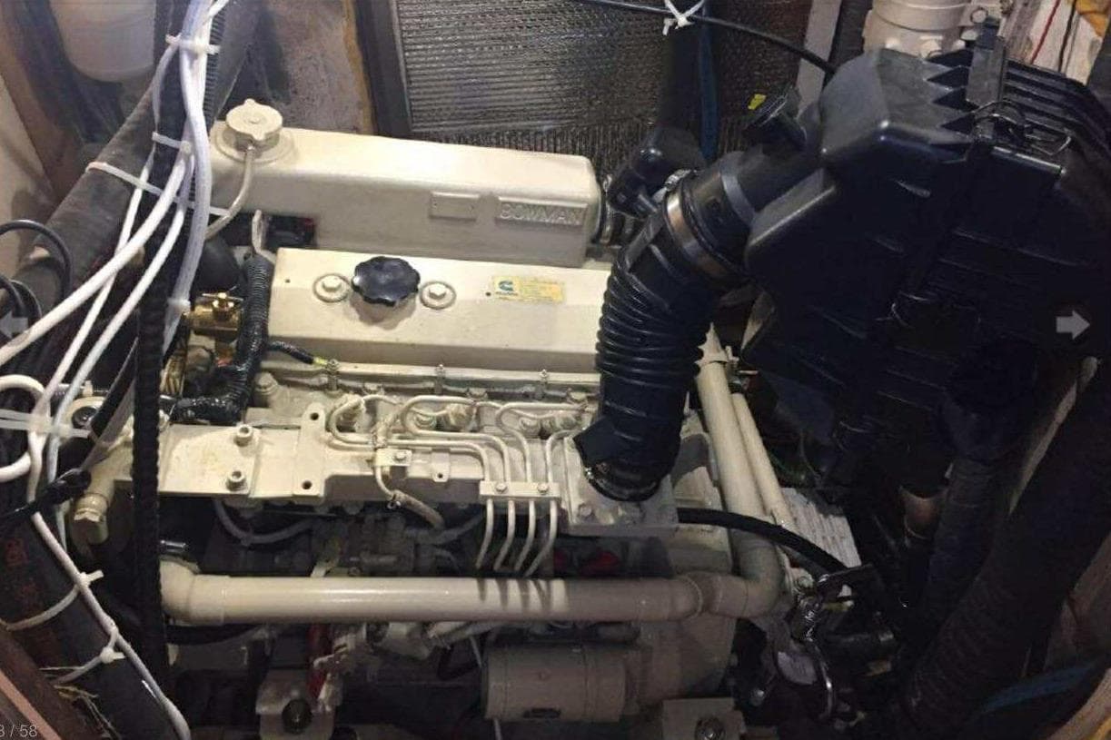 Engine compartment of a 1985 Endeavour 42 sailboat, showcasing mechanical components and wiring.