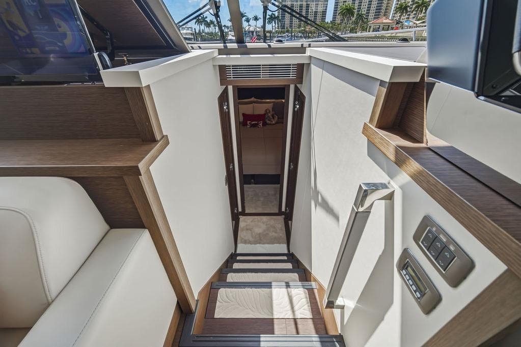 Interior view of 2024 Prestige 520 yacht, featuring modern staircase and luxurious cabin entrance.