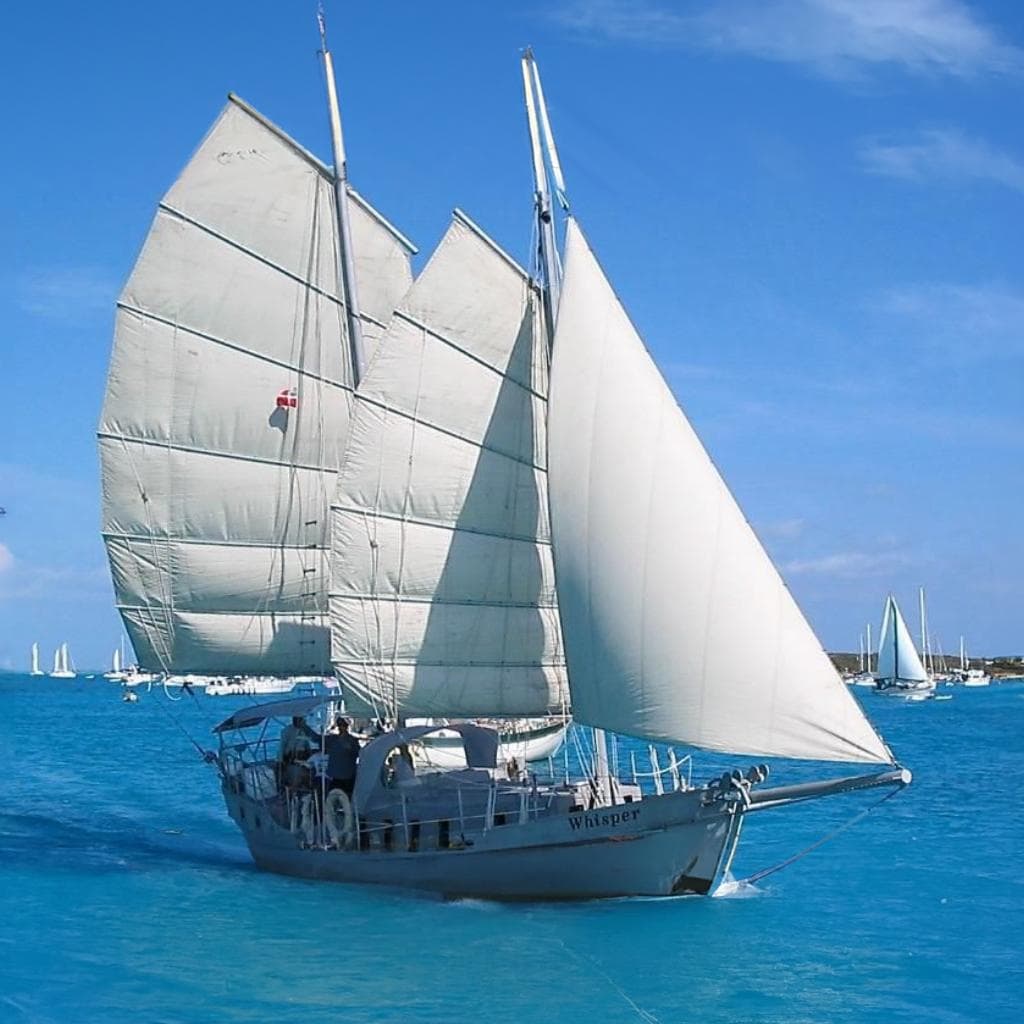 Sailing yacht "Whisper," Colvin Gazelle Custom 1974, navigating clear blue waters.