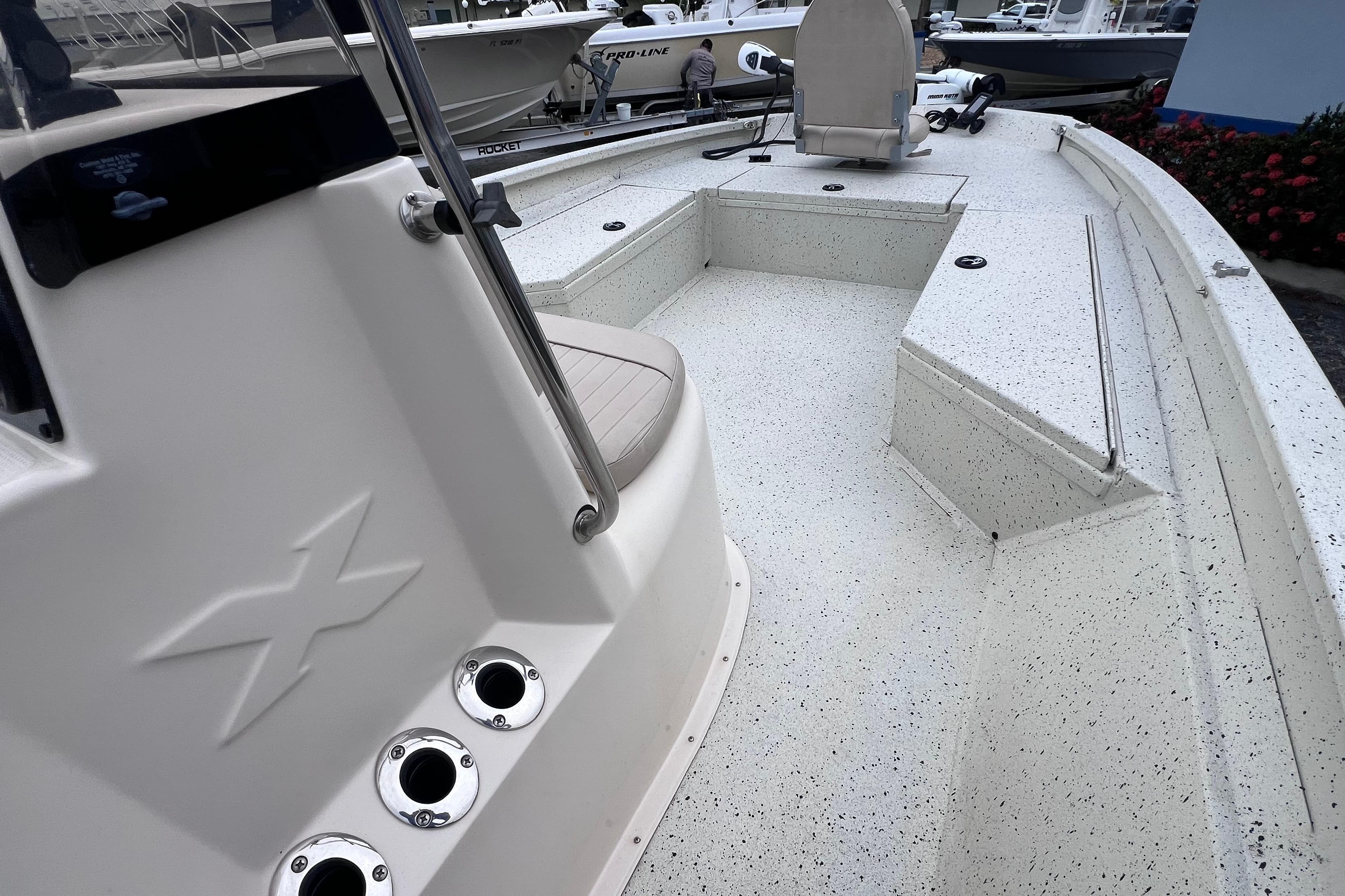 2014 Xpress H22B Bay boat interior with speckled deck and seating area.