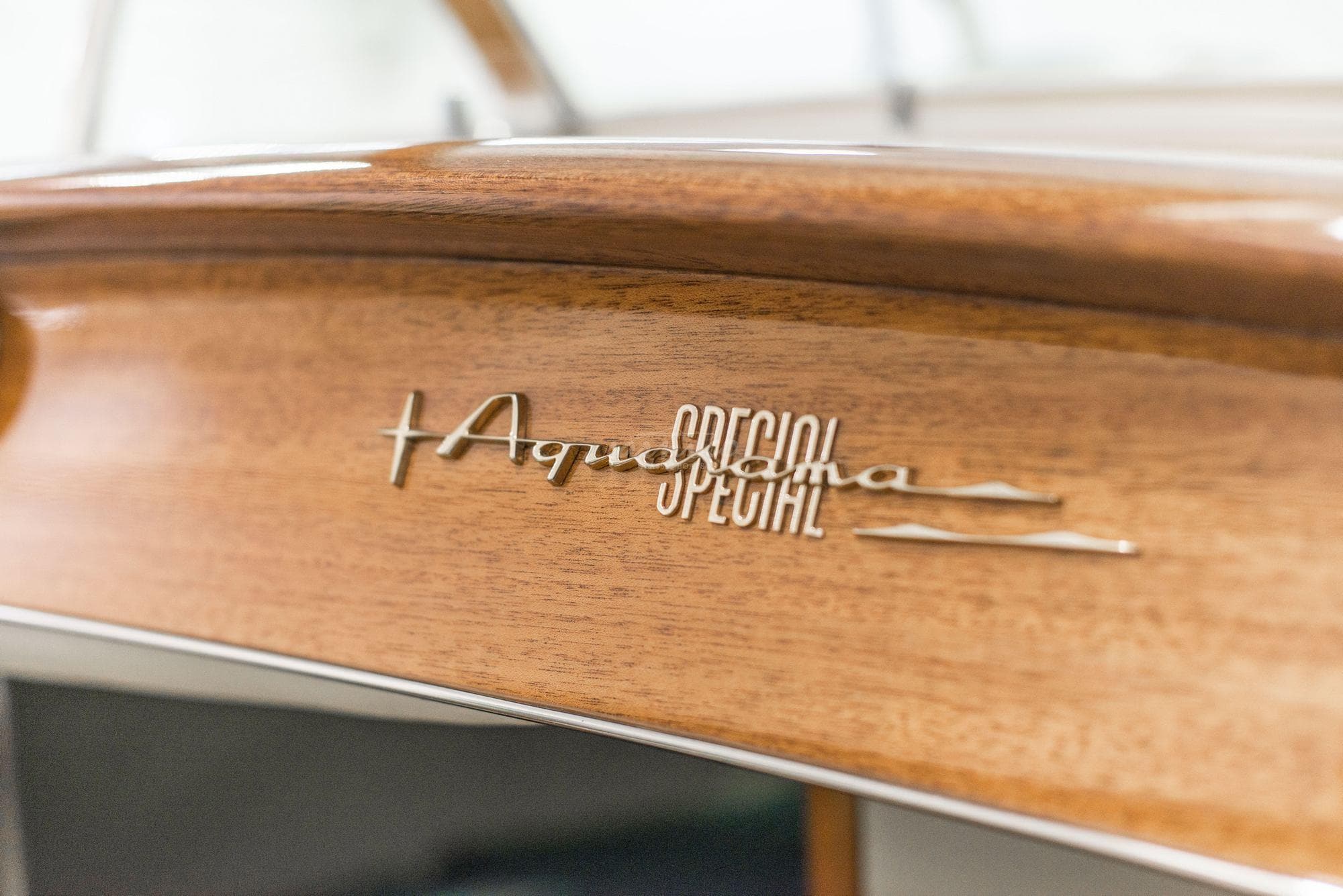 Close-up of Riva Aquarama Special 1991 emblem on wood.