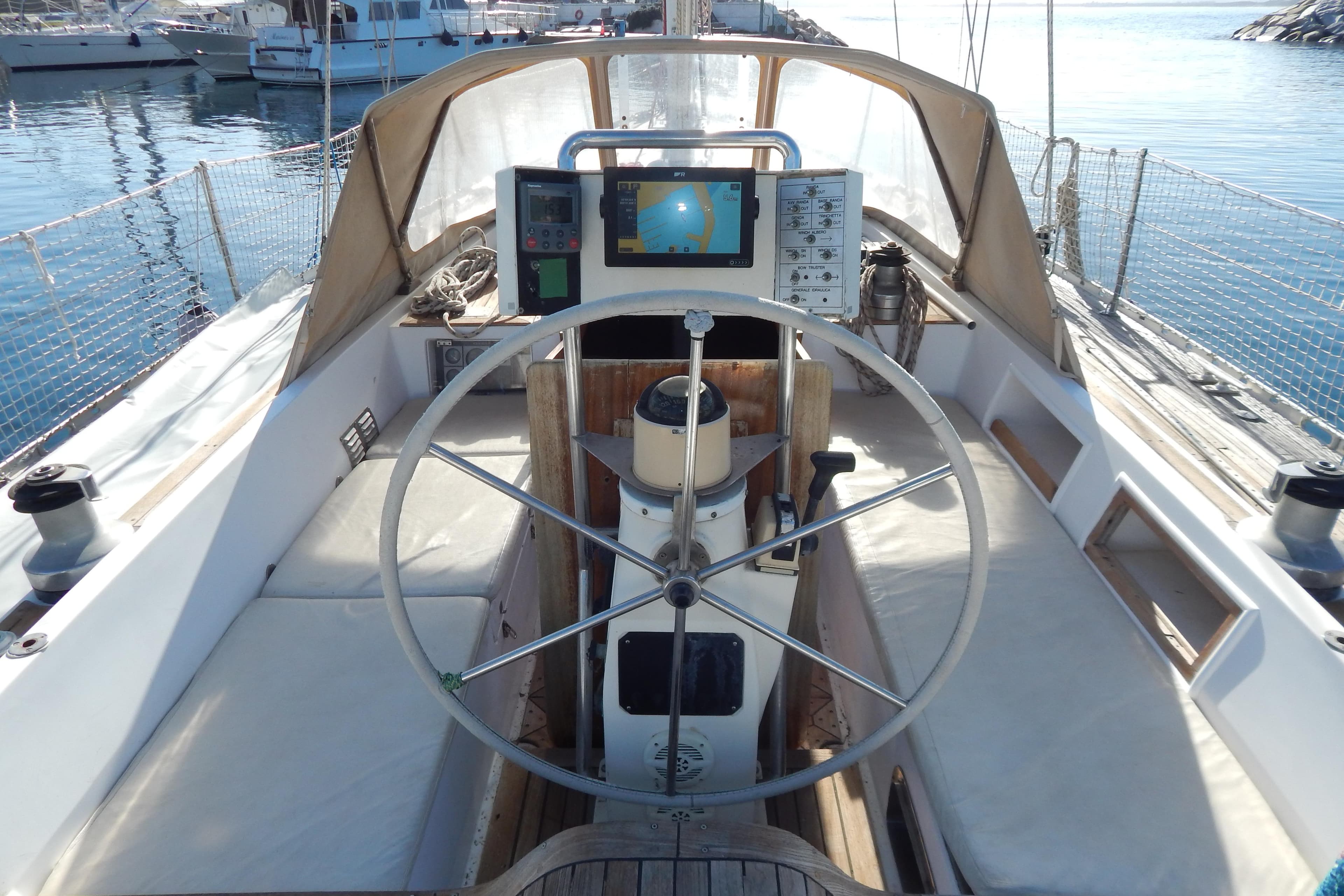 Cockpit of 1992 Tayana 55 sailboat with steering wheel and navigation equipment.