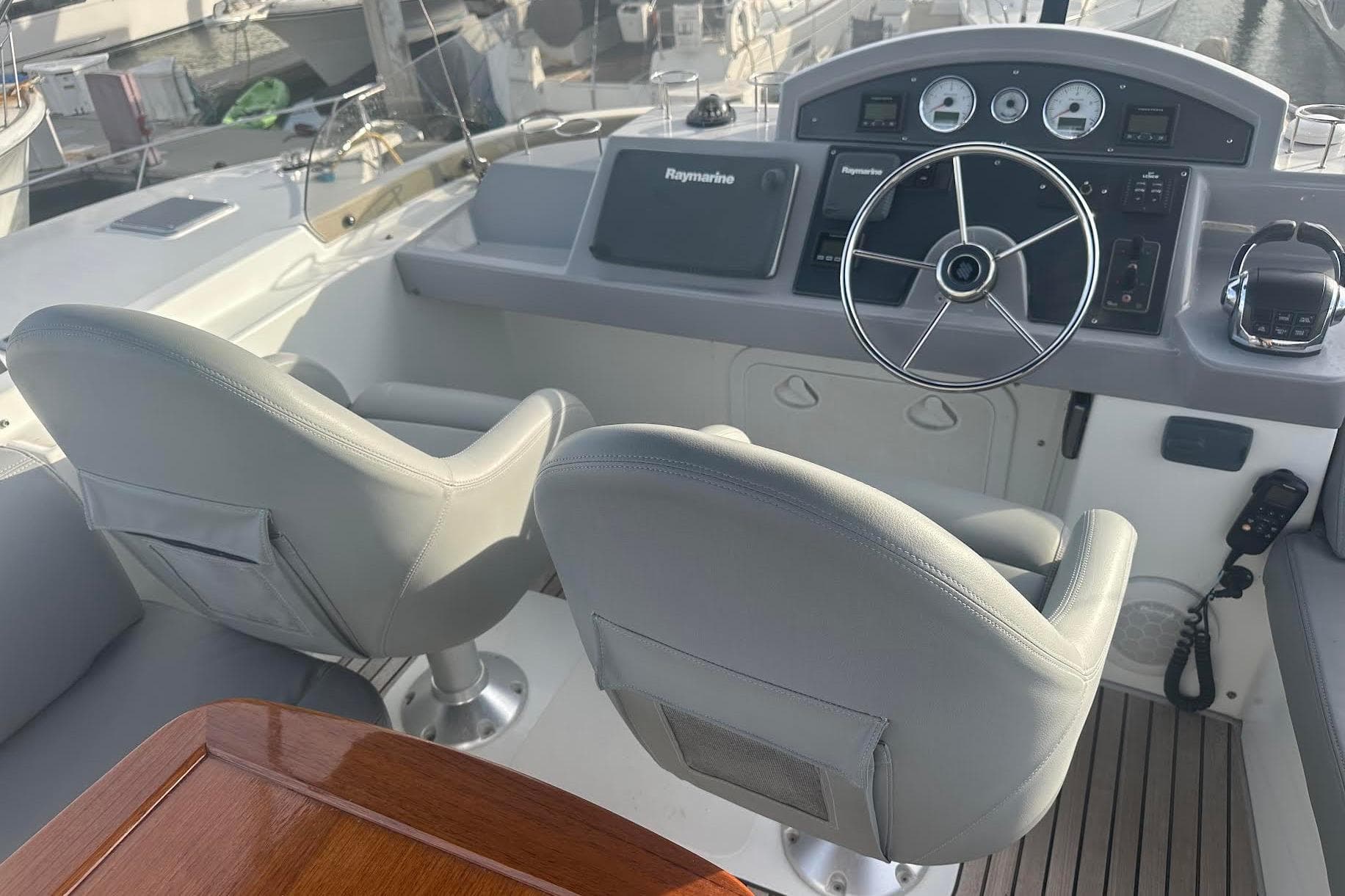 Helm of 2015 Beneteau Swift Trawler 44 with dual seats and navigation controls.