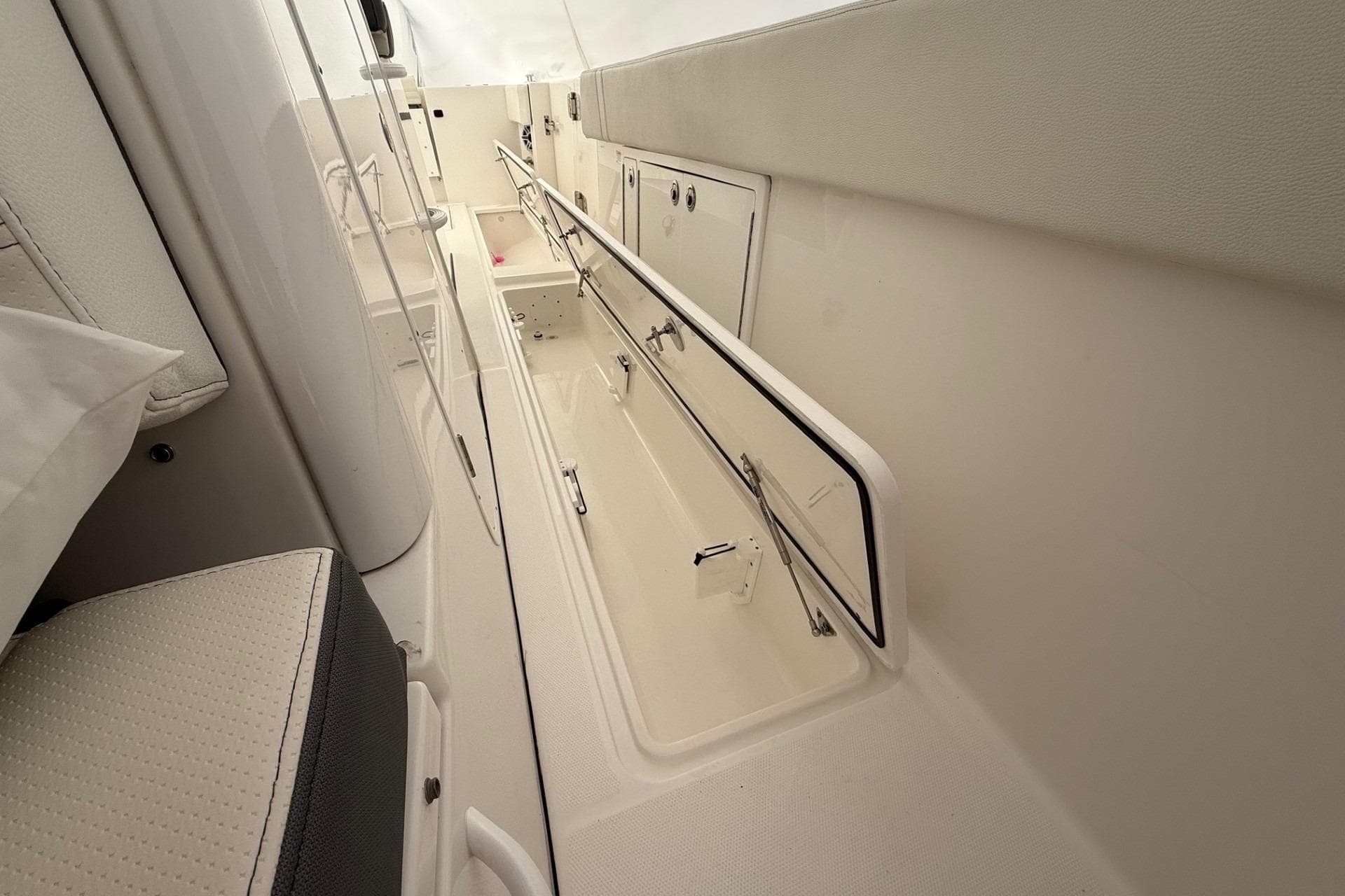 Interior view of 2023 Edgewater 340CC boat, showcasing storage compartments.
