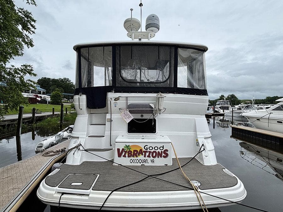2004 Cruisers Yachts 375 Motoryacht docked, rear view with "Good Vibrations" signage.