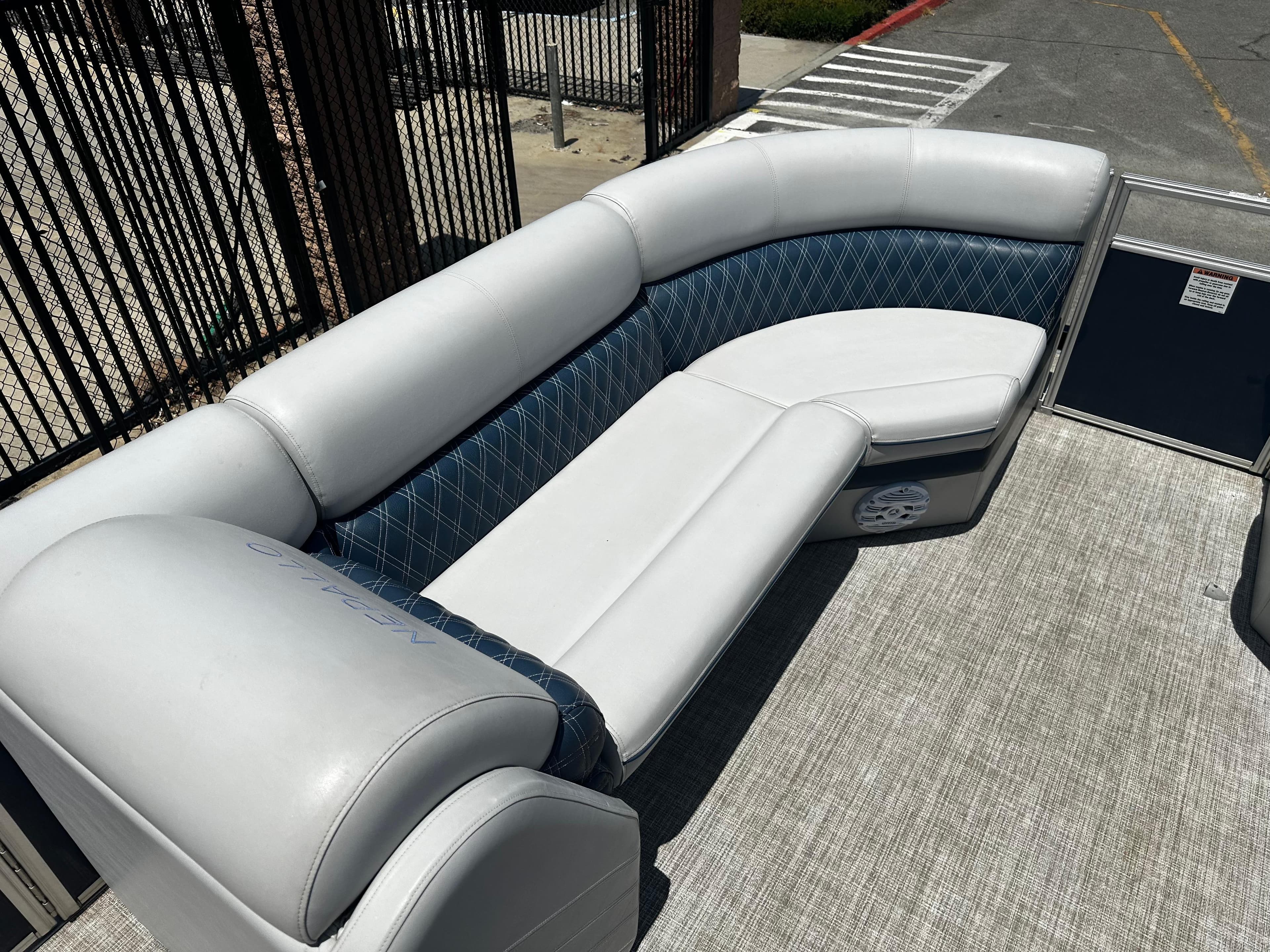 2022 Nepallo CW24-ST24QL boat with white and blue cushioned seating.