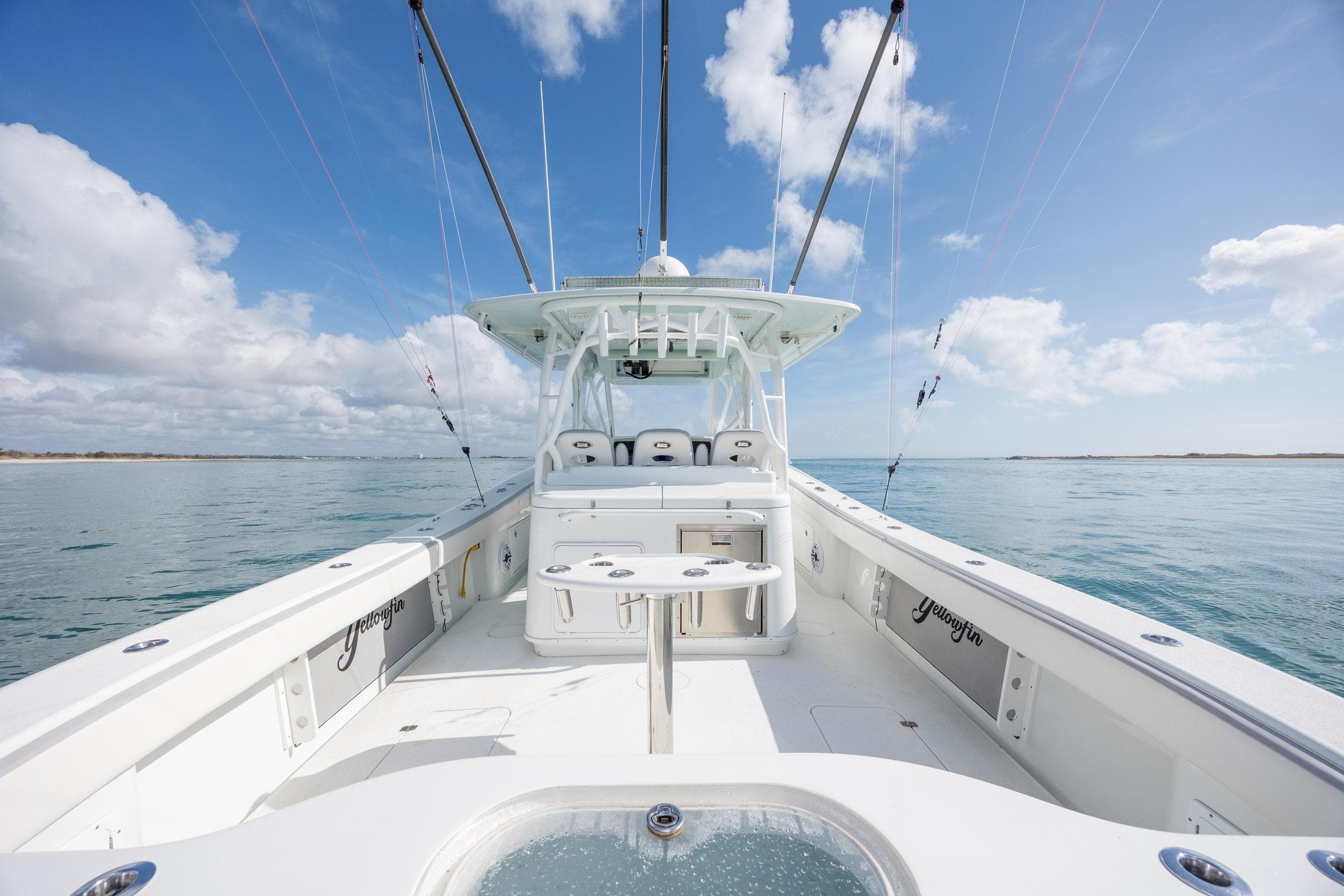 2014 Yellowfin 42 Offshore boat on calm sea under blue sky.