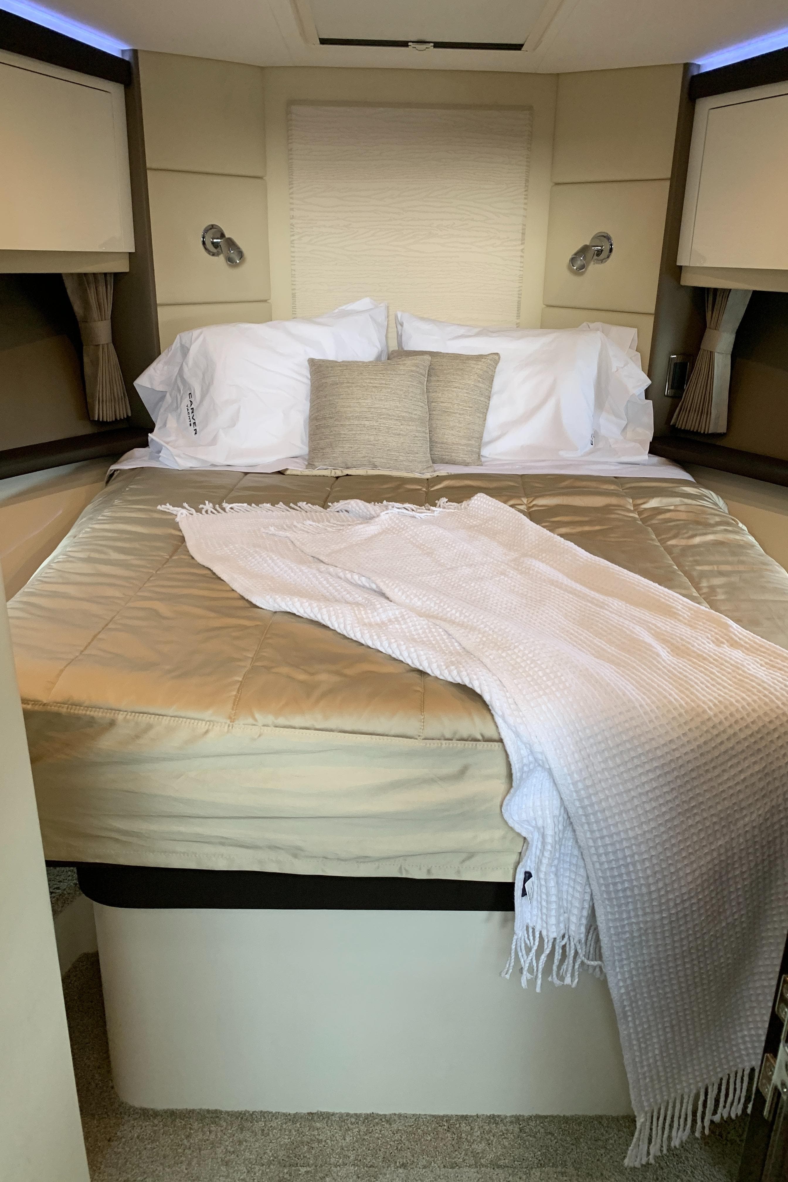 Luxurious bedroom in 2020 Carver C37 Coupe yacht with cozy bedding.