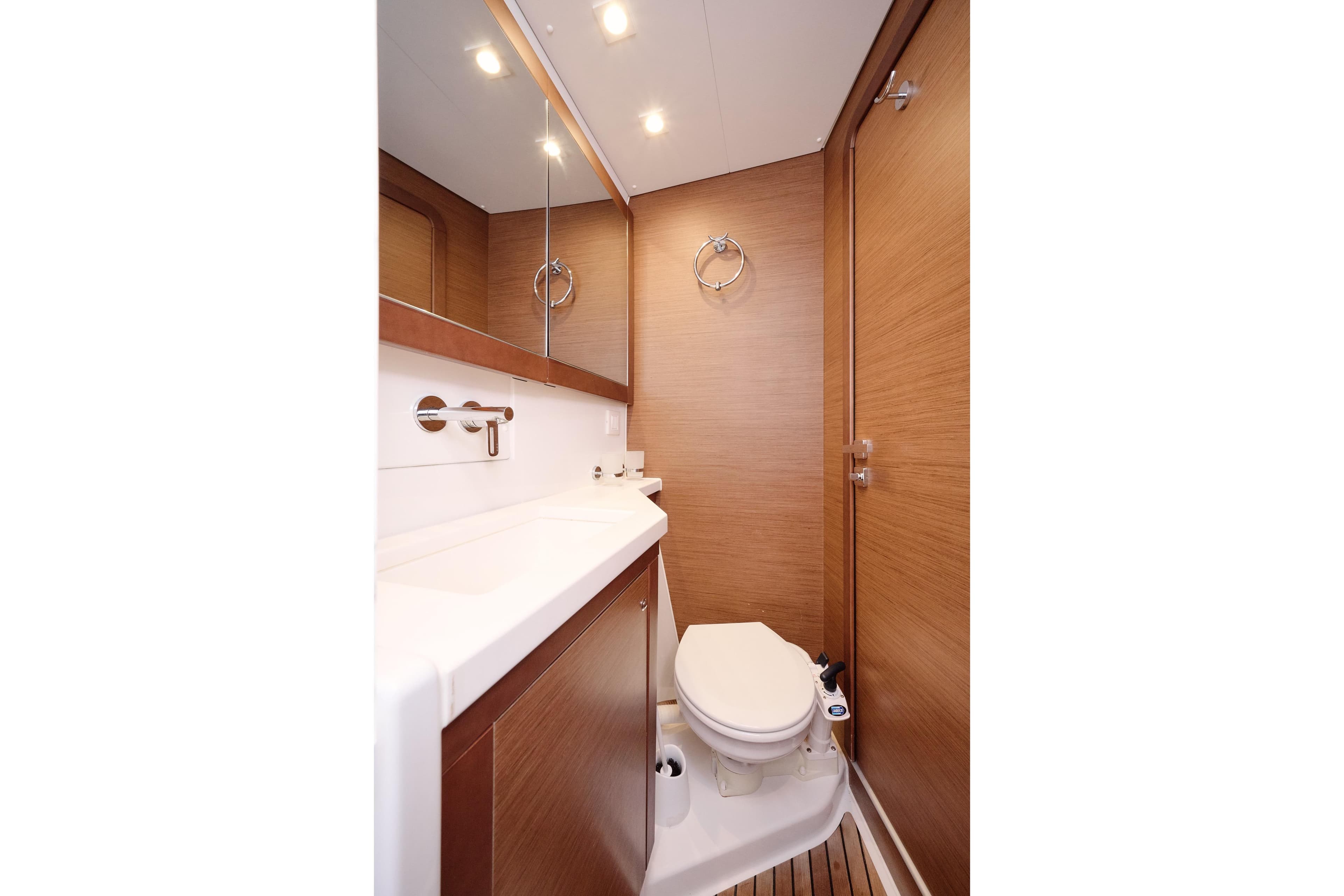Interior of 2018 Lagoon 450 yacht bathroom with wooden finish and modern fixtures.