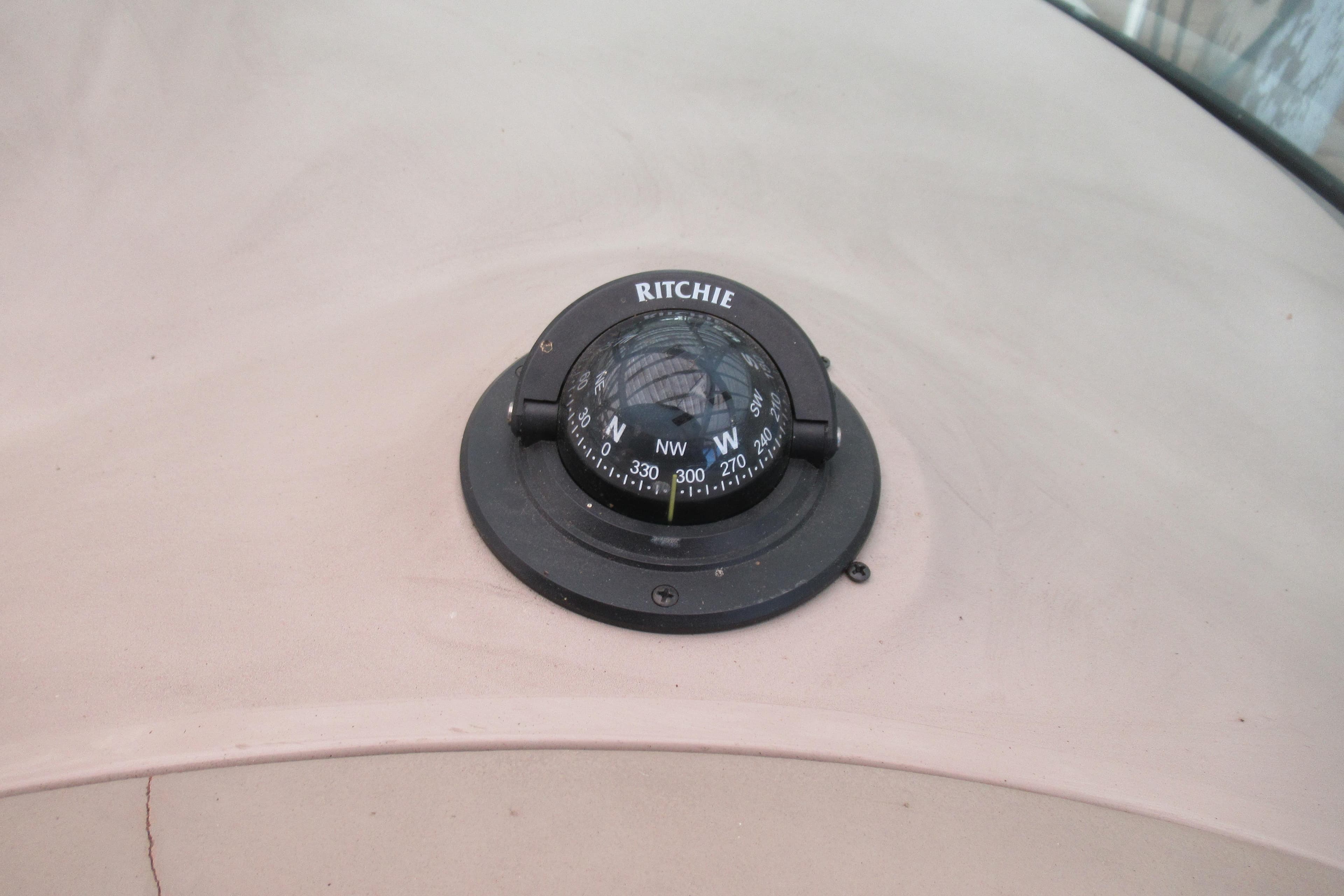 Ritchie compass on 2001 Searay 280 Sundancer boat dashboard.