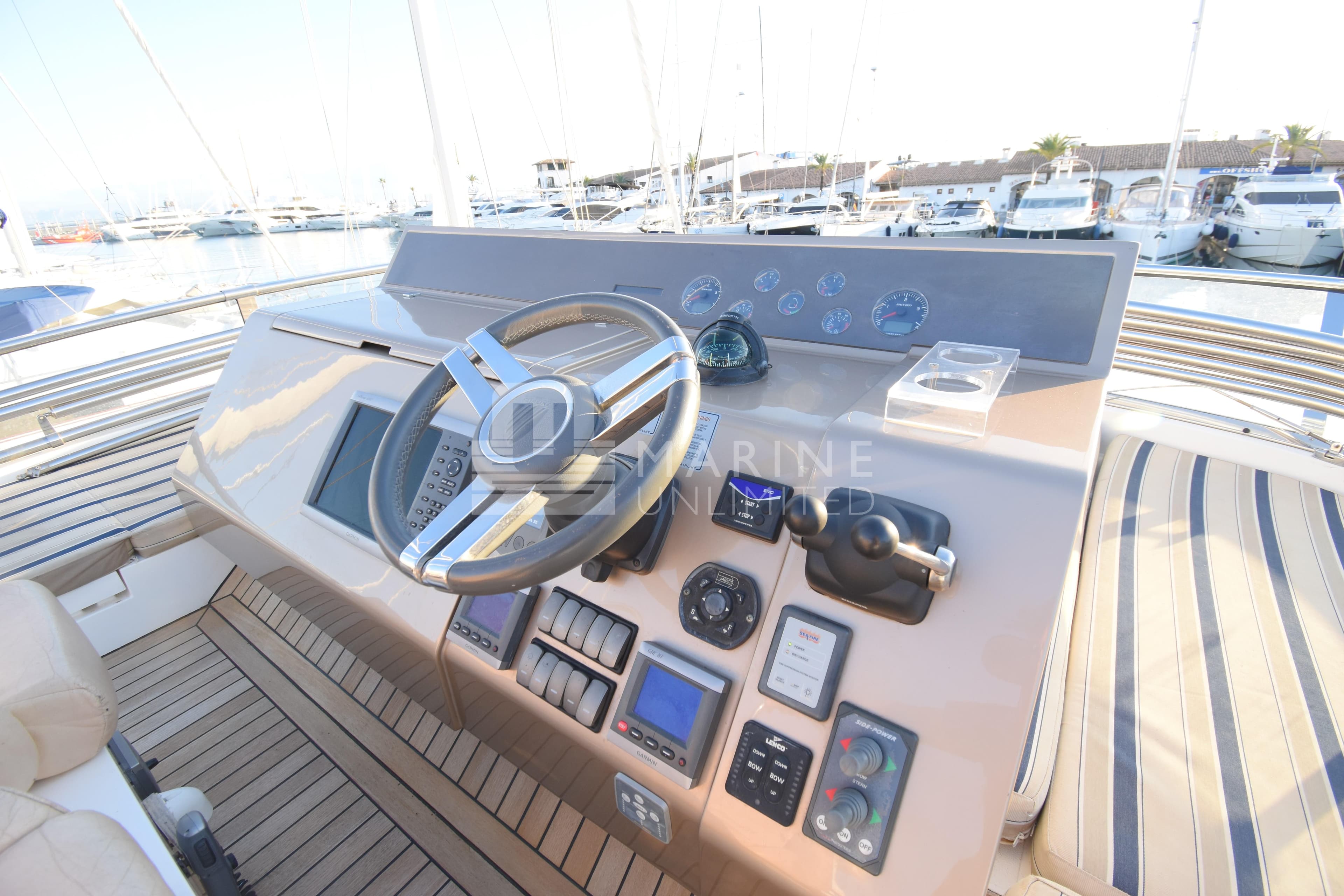 Helm of 2010 Fairline Squadron 55 yacht with modern controls and steering wheel.
