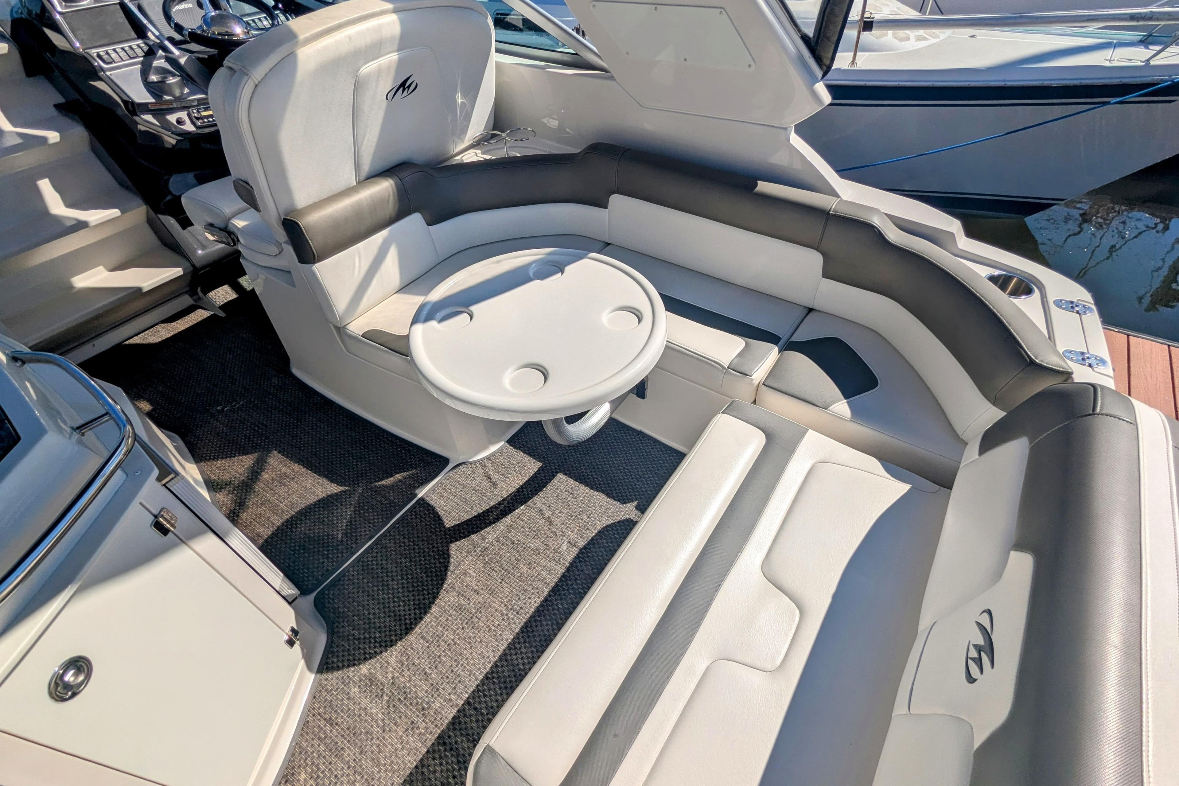 2013 Monterey 280 Sport Yacht interior with seating and table, showcasing luxury design.