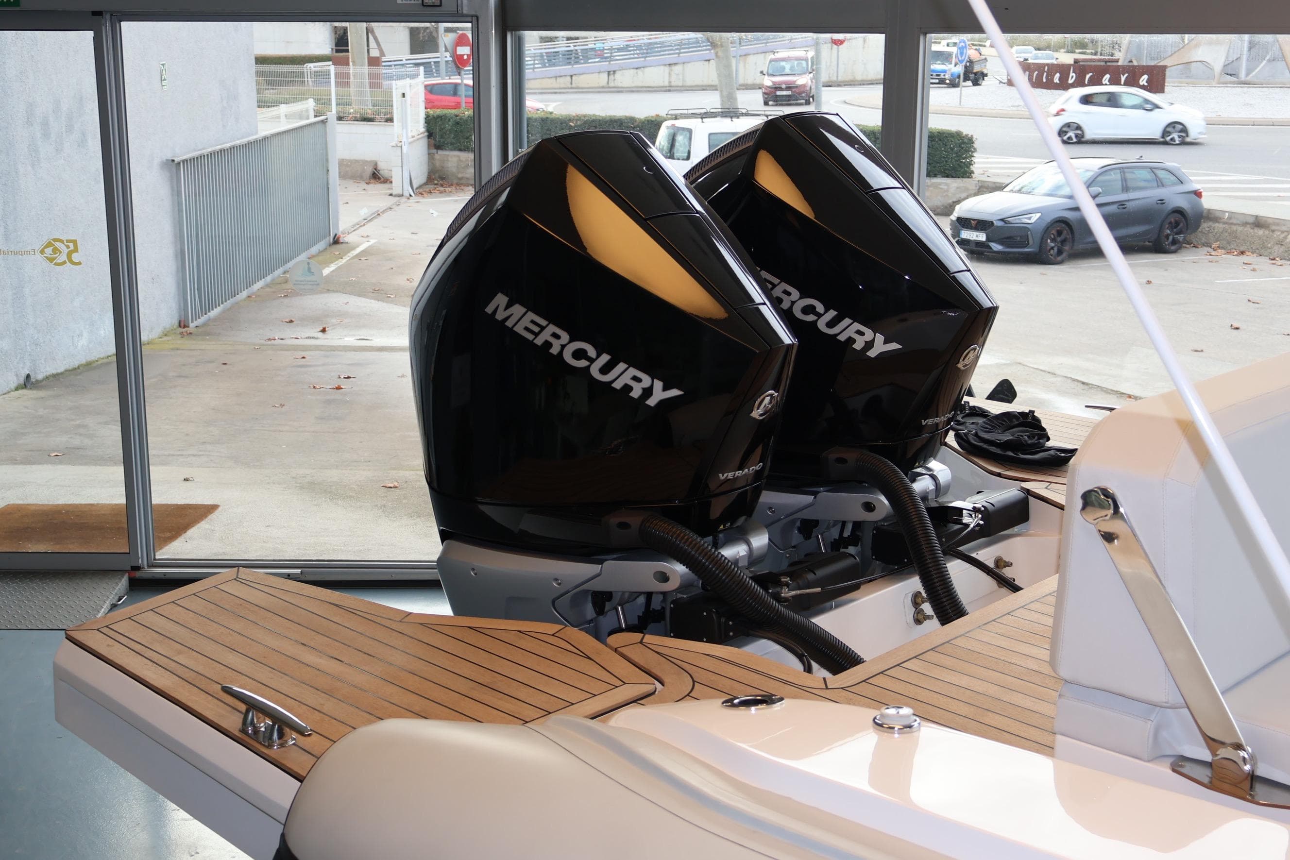 Twin Mercury Verado engines on a 2026 Pirelli 30 boat, docked indoors.