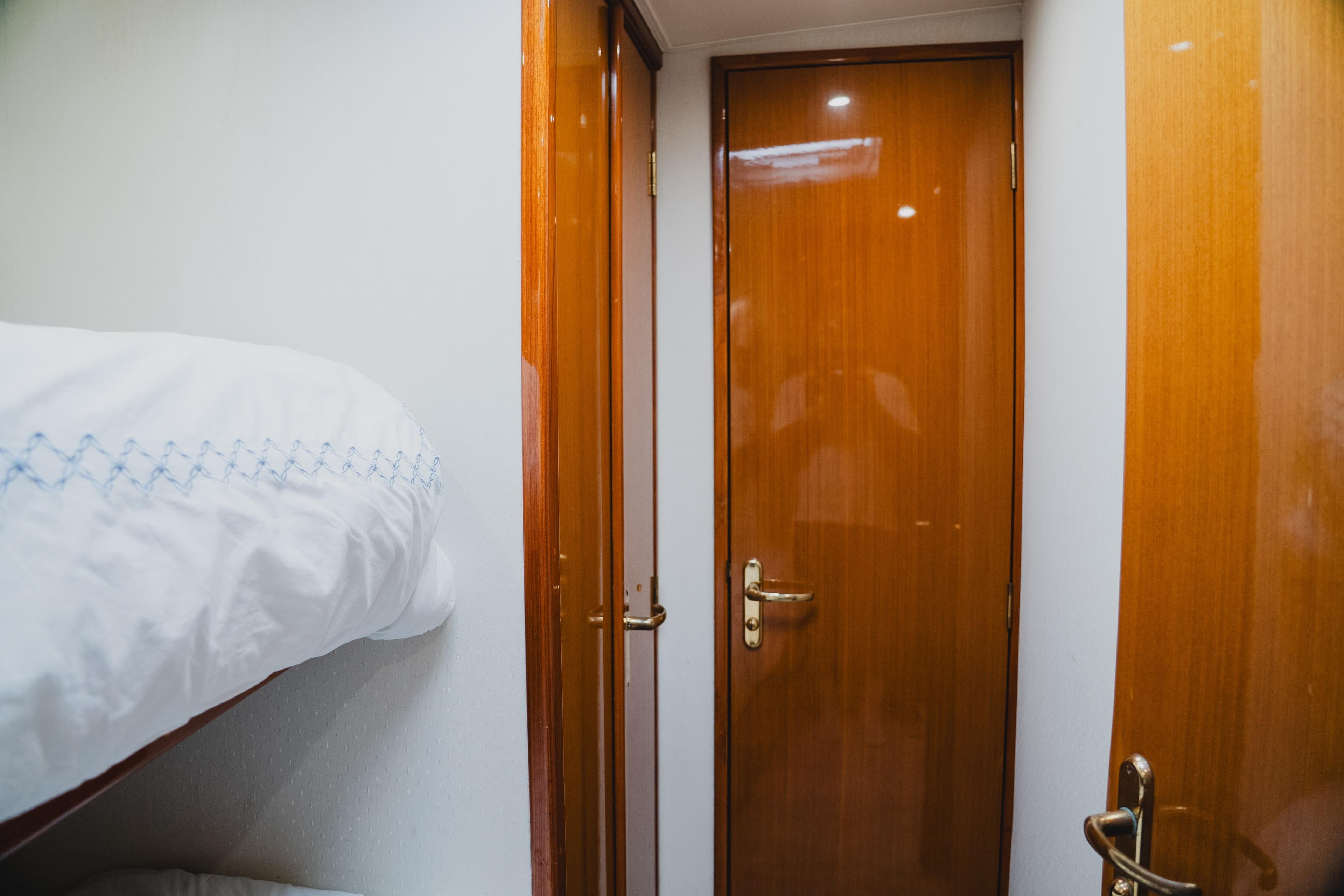 Interior of 1999 Viking 58 Convertible yacht with wooden doors and bunk bed.