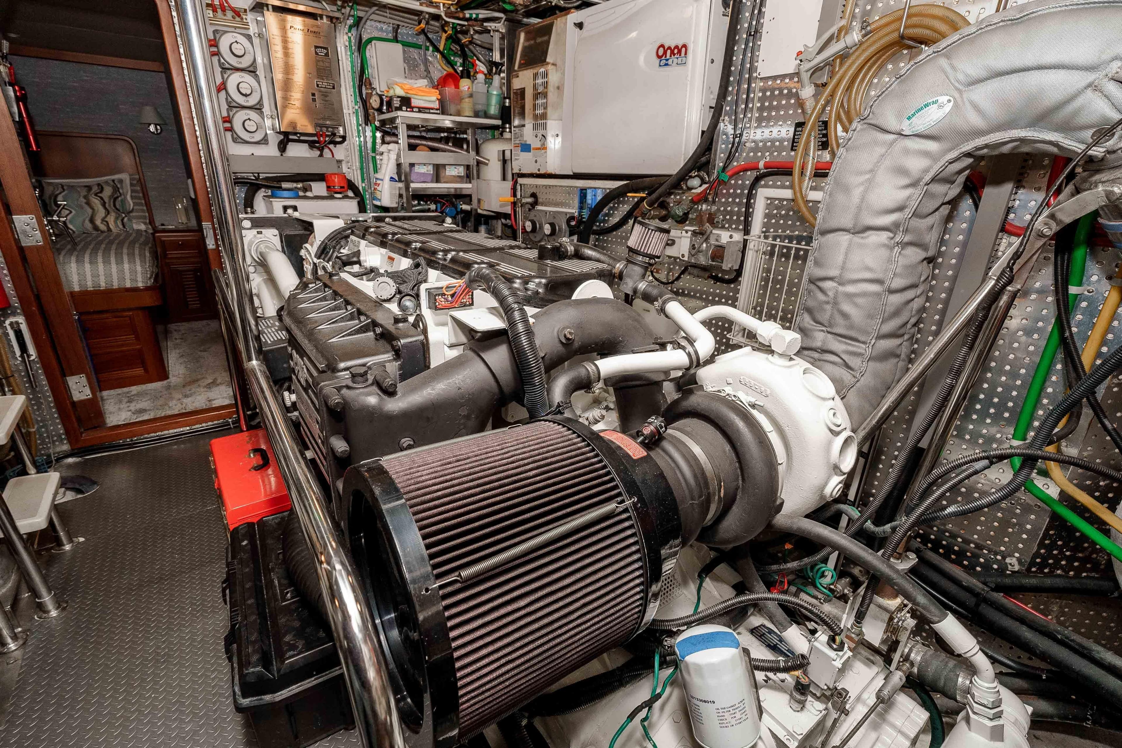 Engine room of a 2000 Offshore Yachts Flushdeck, showcasing detailed mechanical components.