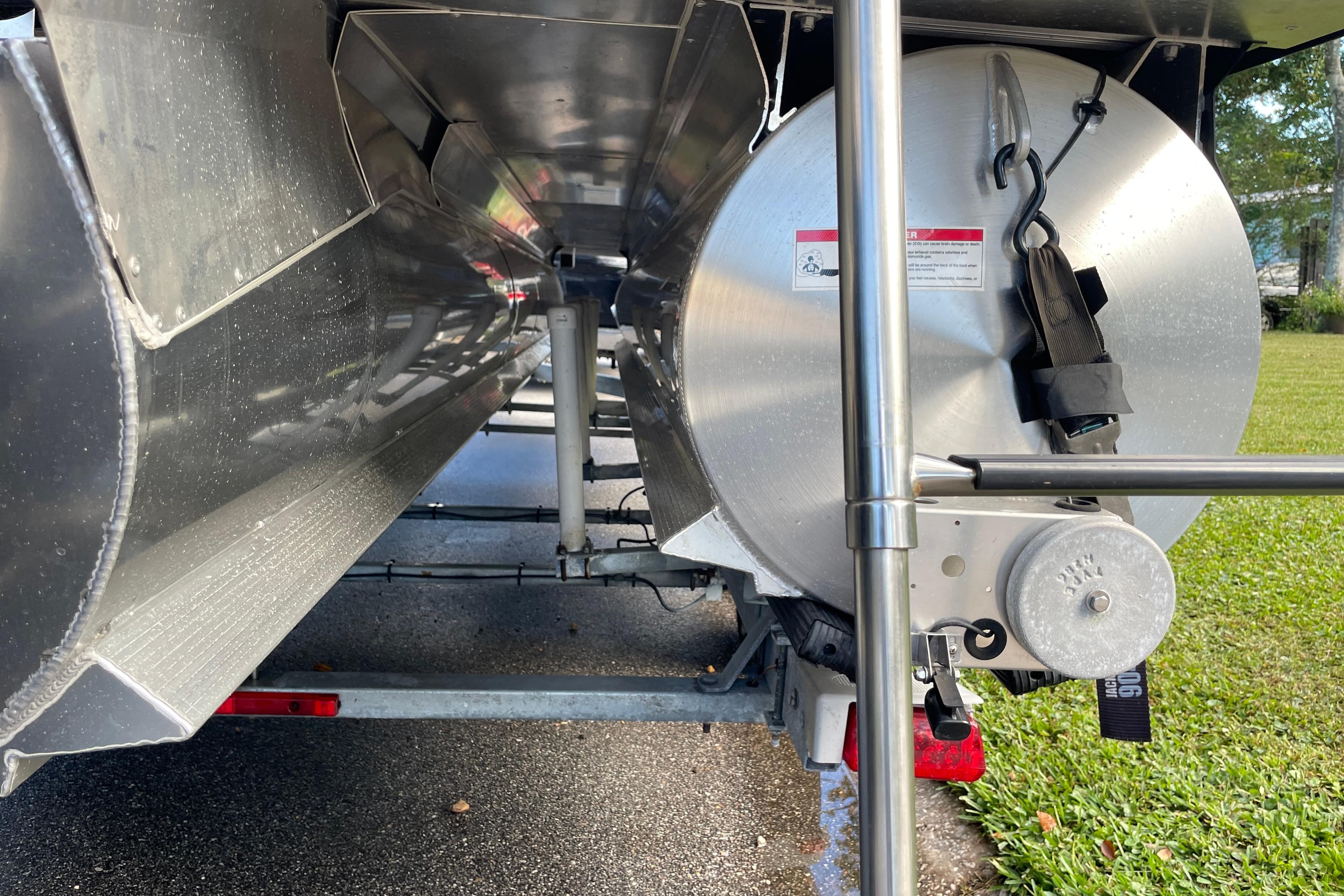 Underneath view of a 2022 Barletta Cabrio 22QC pontoon boat on a trailer.