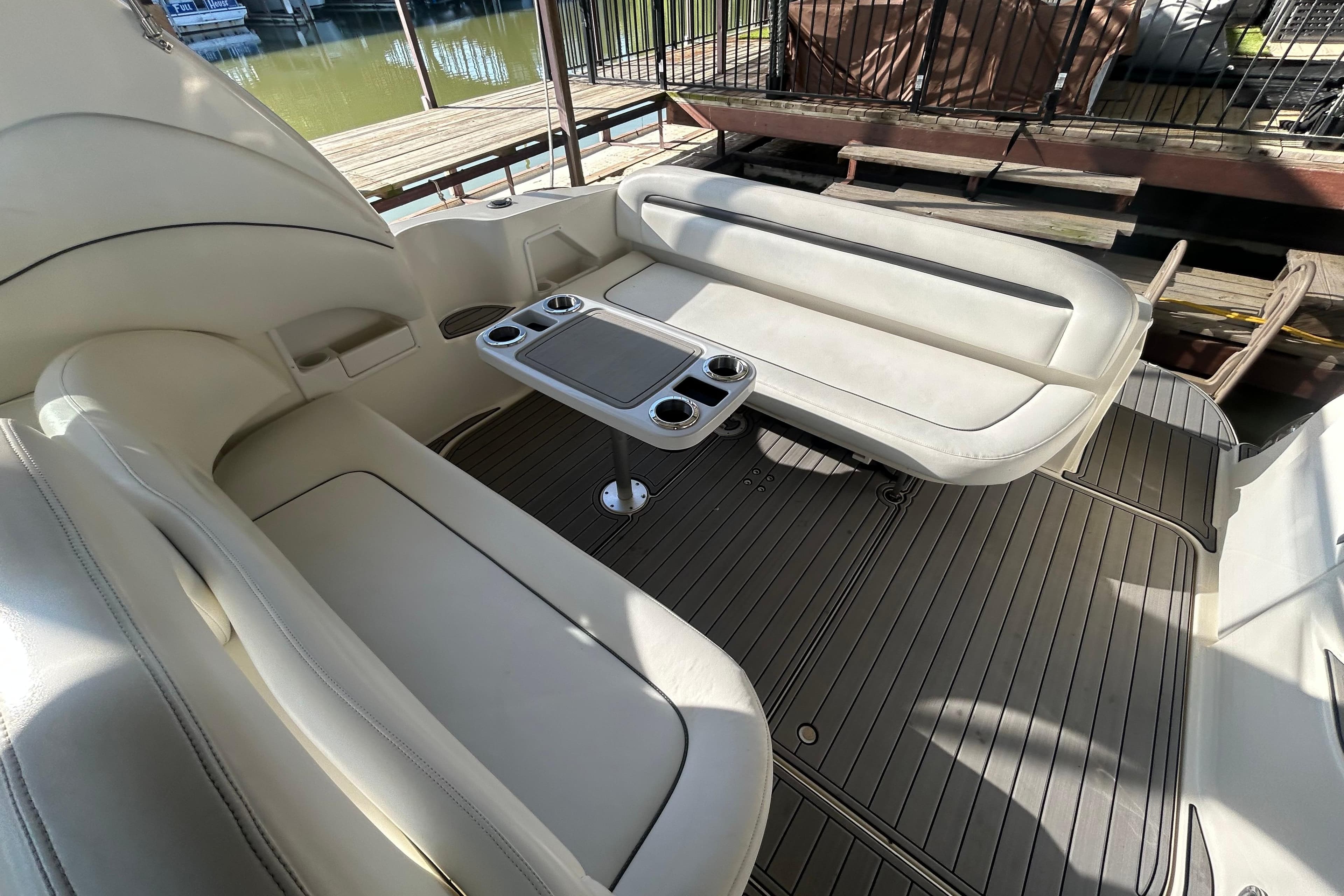 2004 Sea Ray 360 Sundancer boat interior with white seating and table.
