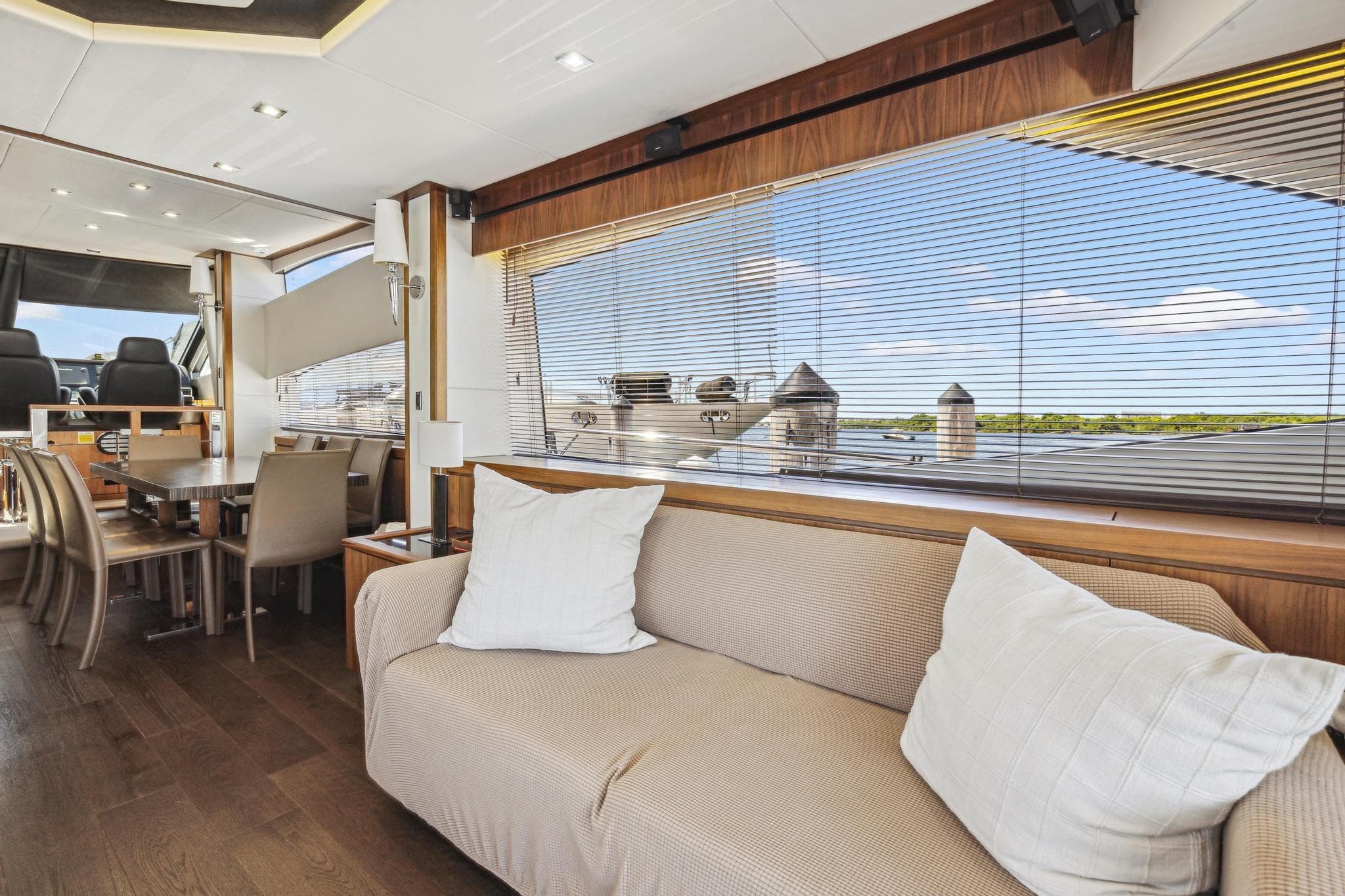 Luxurious interior of 2014 Sunseeker 73 Manhattan yacht with elegant seating and dining area.