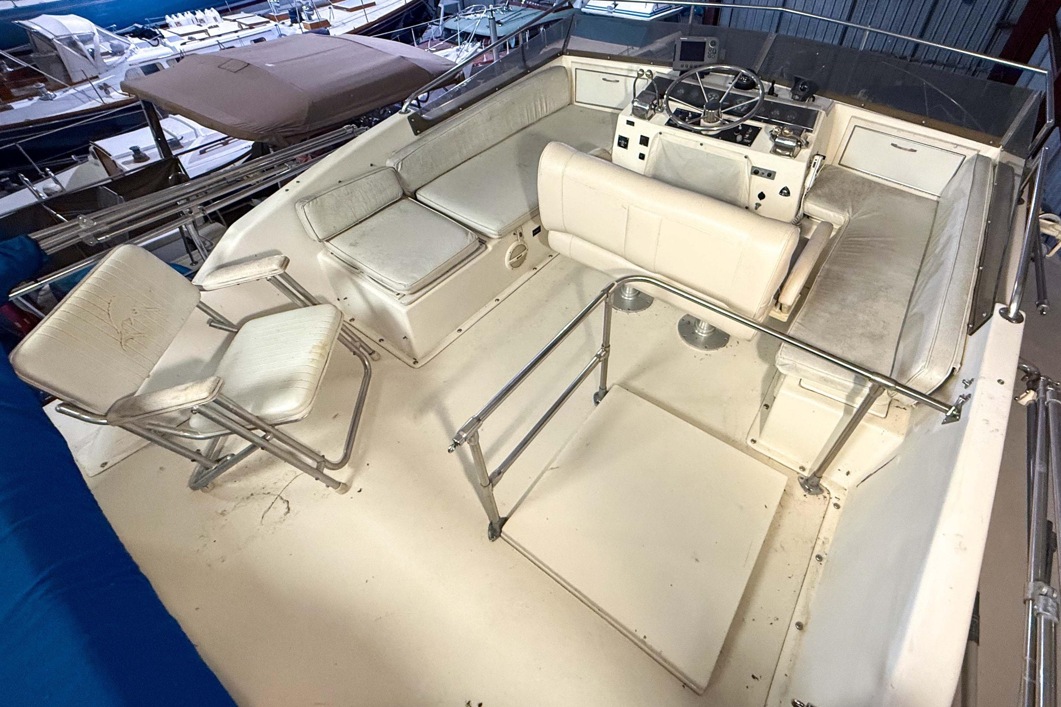 1977 Pacemaker FB Motor Yacht cockpit with white seating and steering console.
