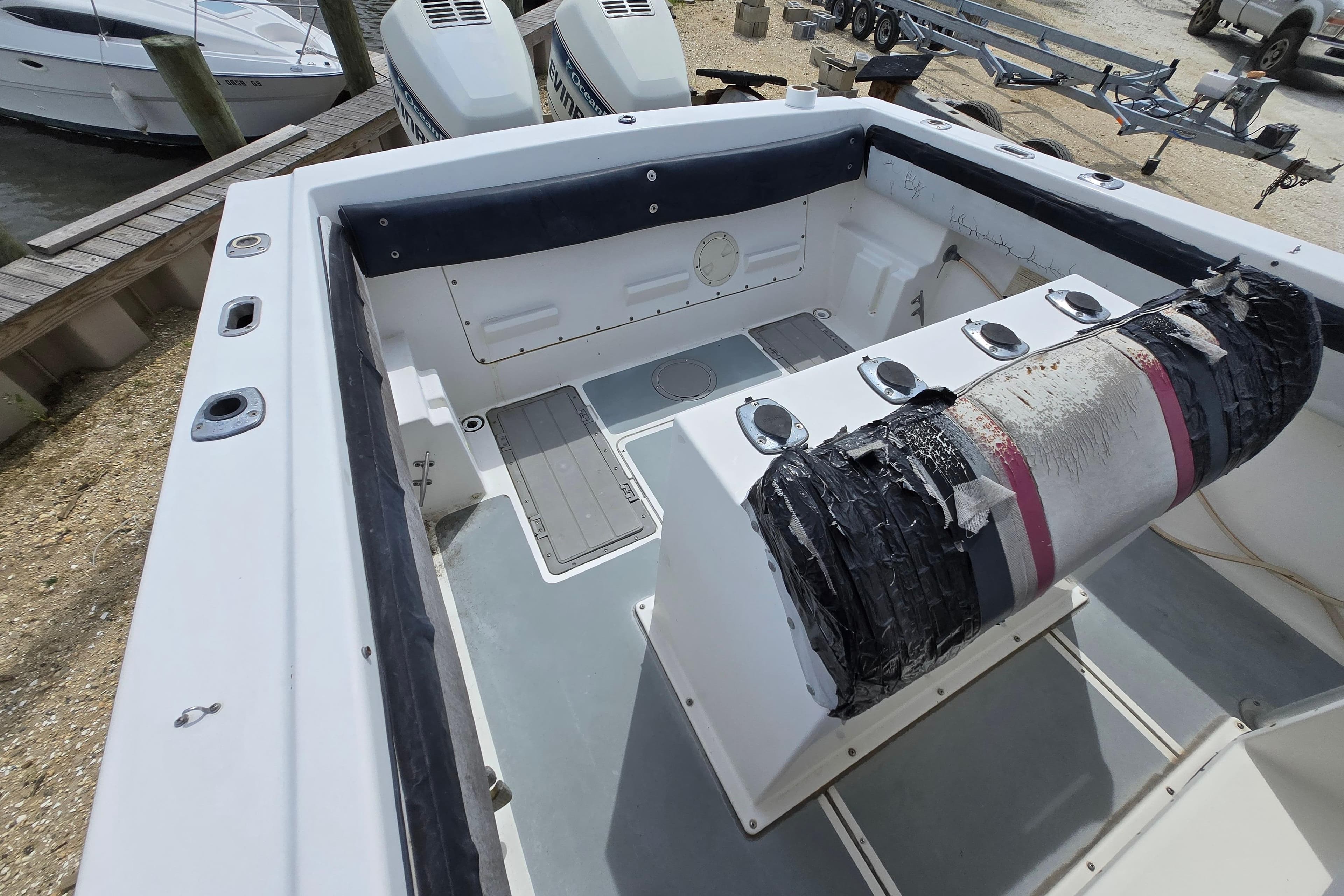 1988 Baja 280 Sportfish boat interior with dual engines and seating area.