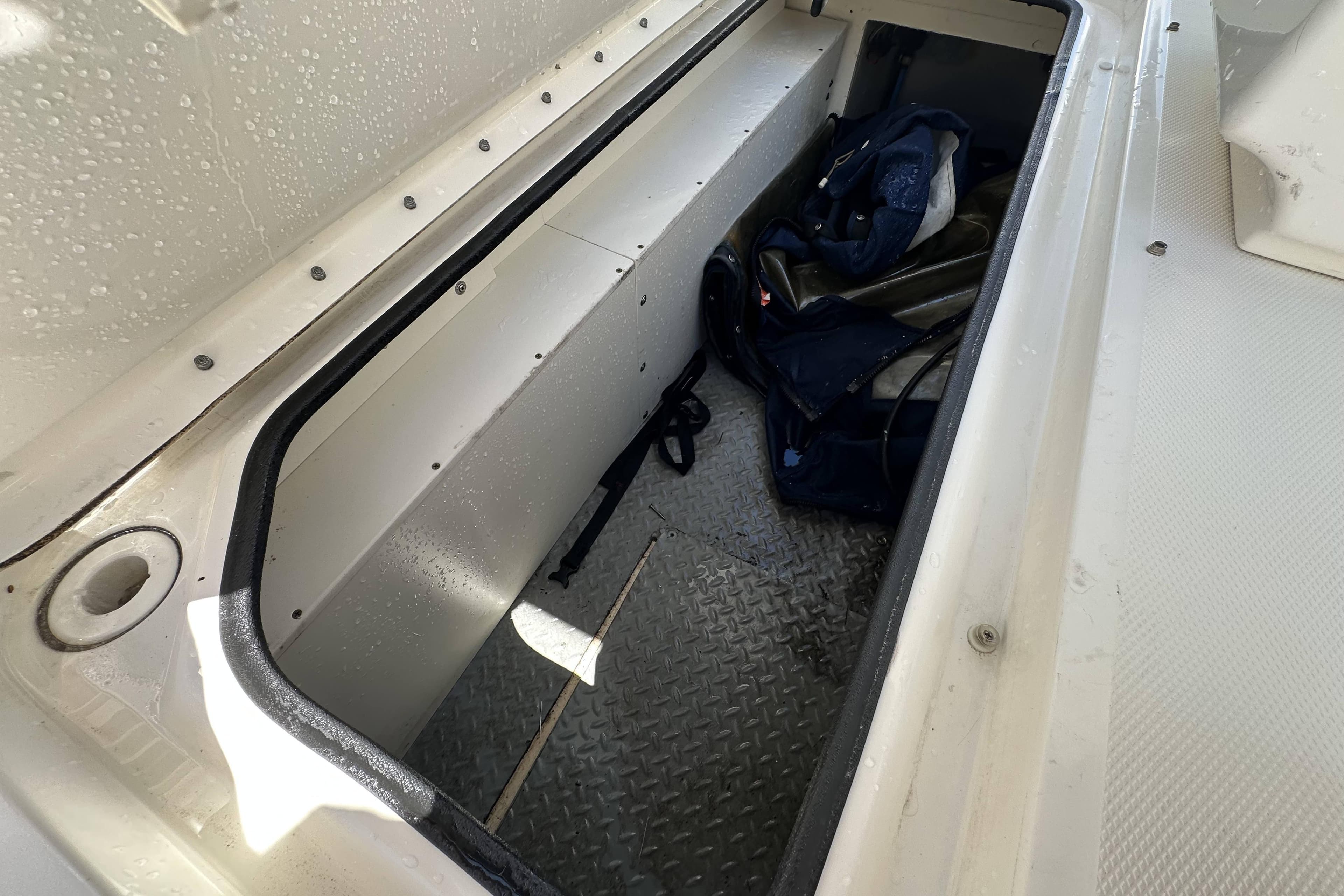 Storage compartment of a 2012 Sea Ray 300 SLX boat, featuring wet gear inside.
