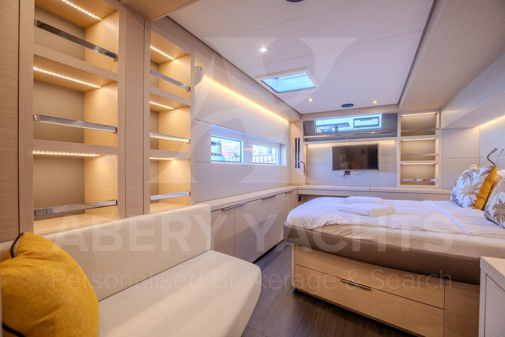 Luxurious interior of 2024 Lagoon 55 yacht with modern design and cozy bedroom.