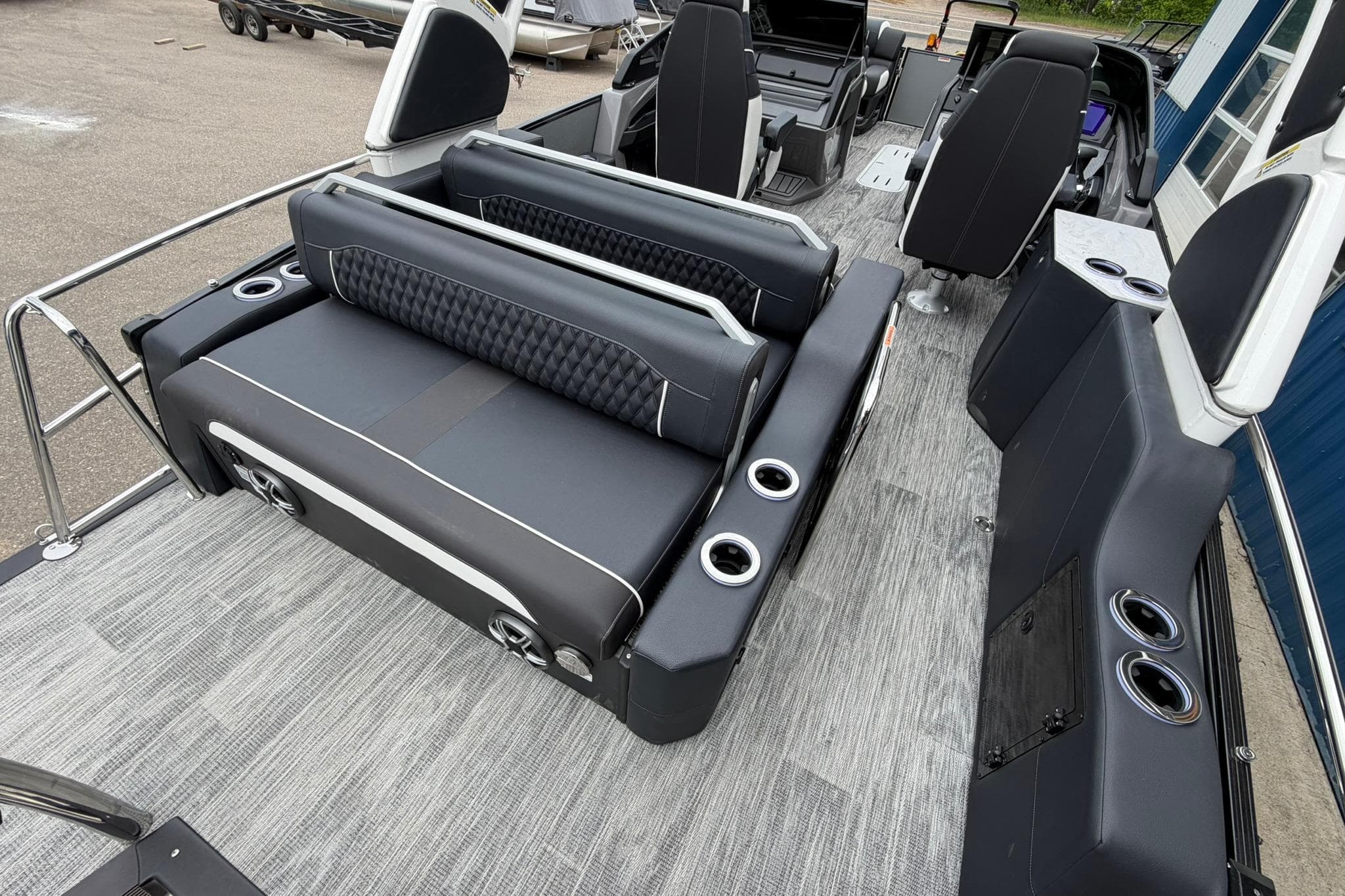 2026 Avalon Excalibur LTD Flex Lounge boat interior with luxurious seating and cup holders.