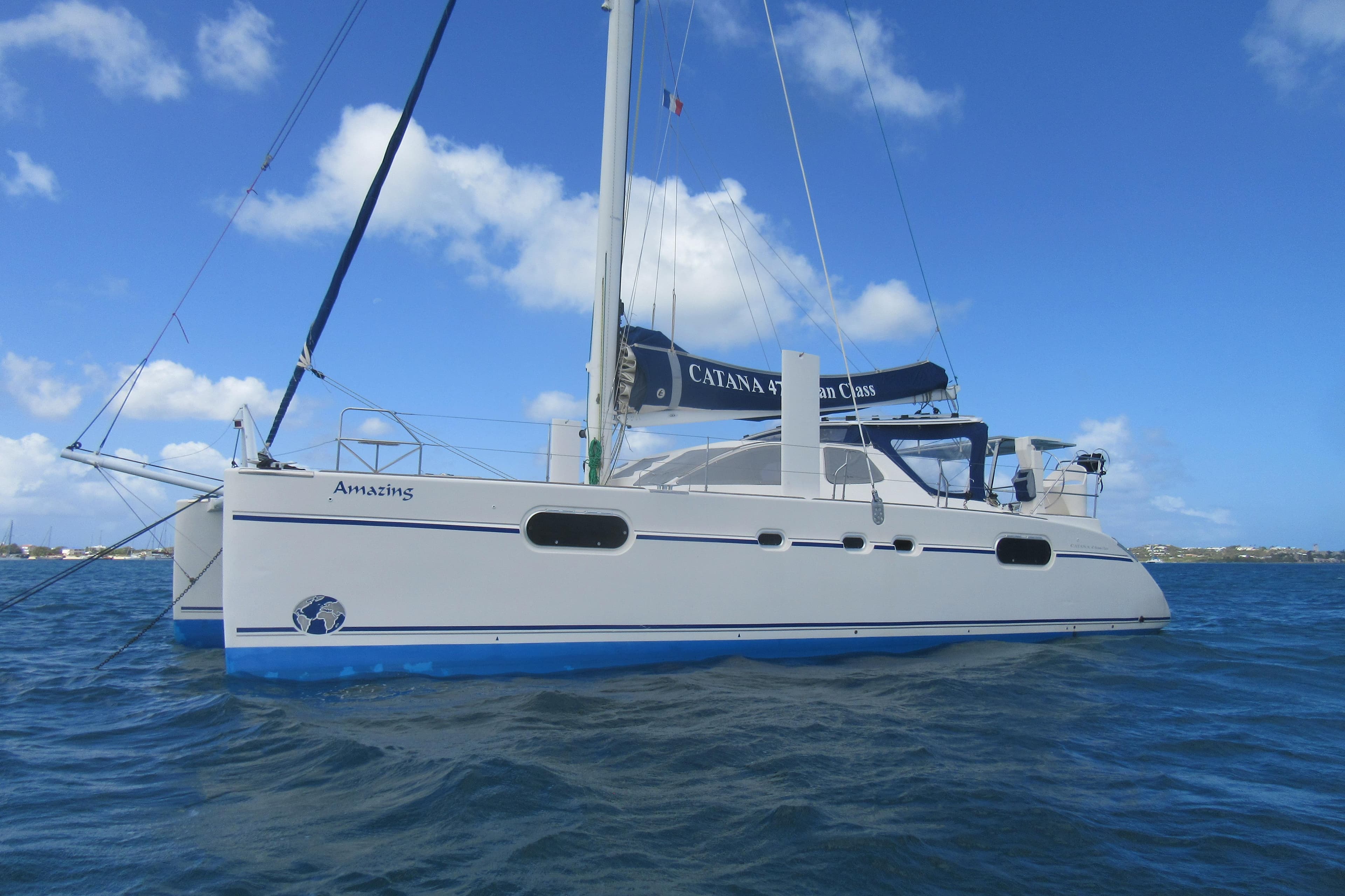 2004 Catana 471 Ocean Class Owner's Version catamaran sailing on blue ocean waters.
