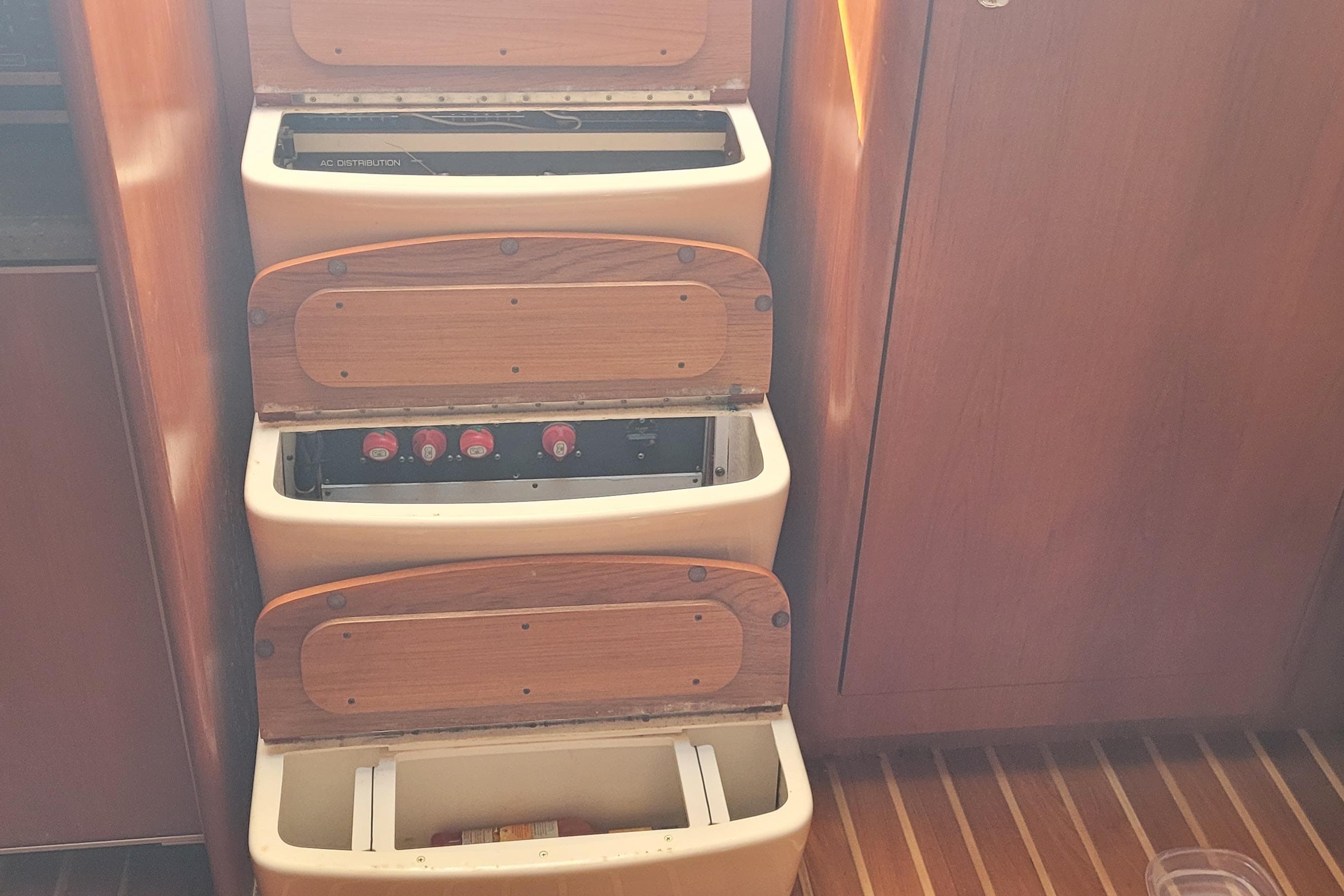 2006 Tiara Yachts 4200 Open interior with wooden storage compartments and control panel.