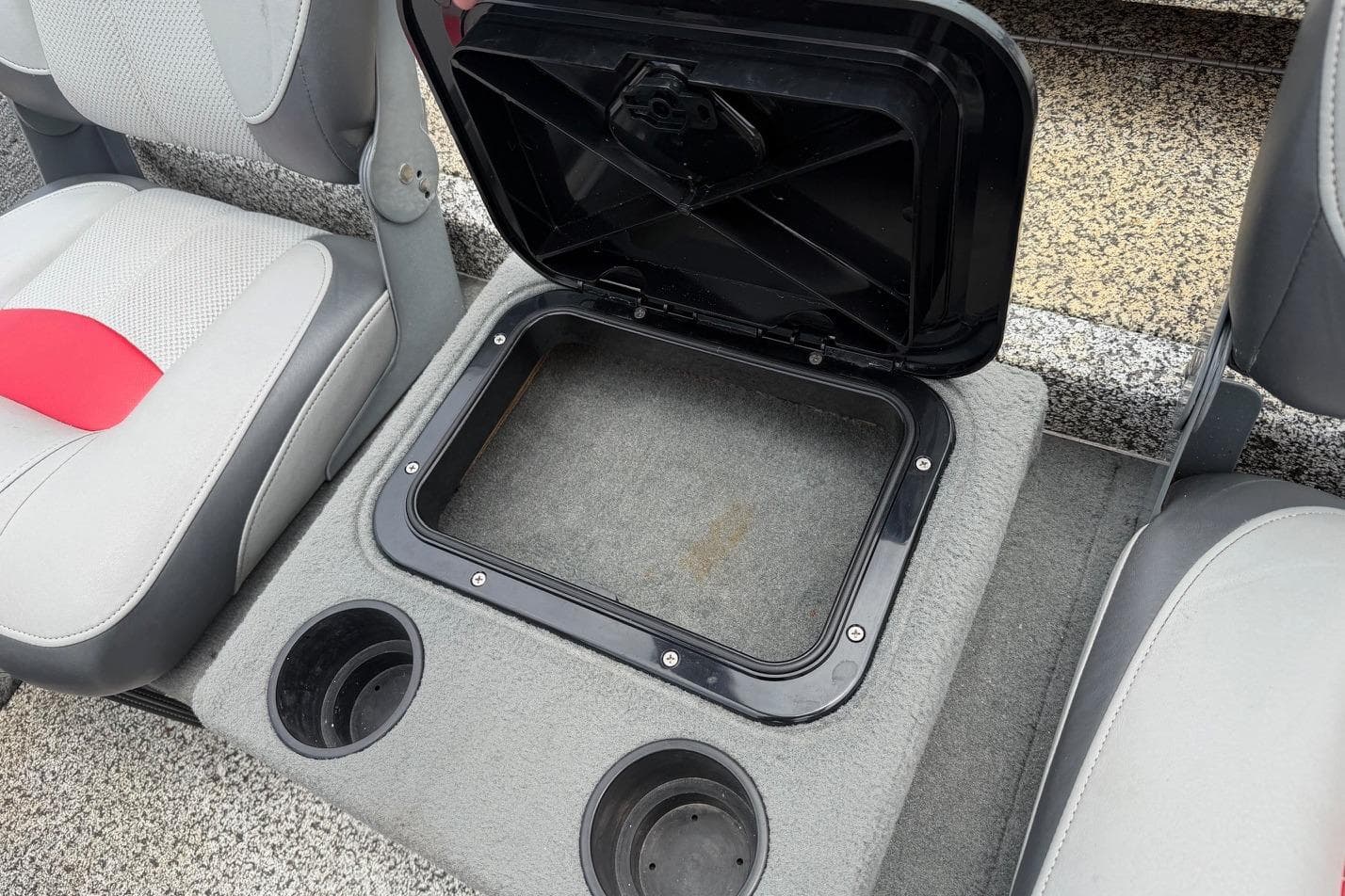 2016 Tracker Pro Team 175 TXW boat interior with open storage compartment and cup holders.