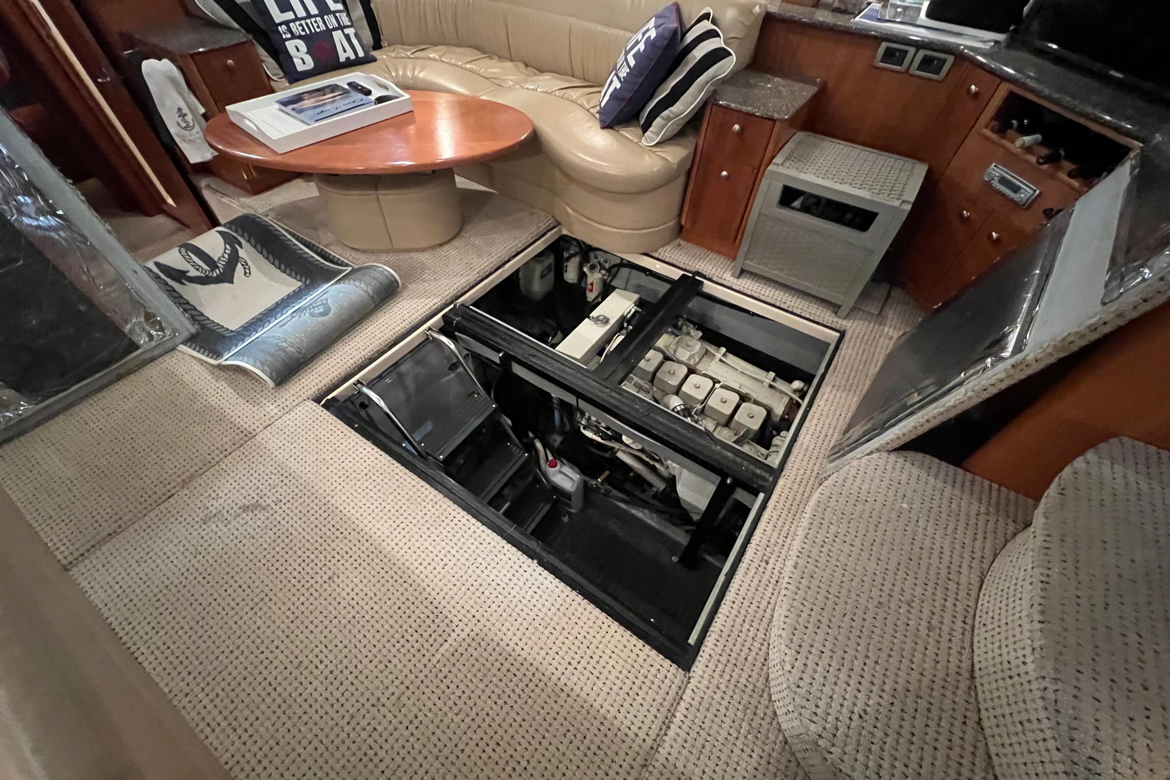 2004 Meridian 408 Motoryacht interior with open engine access panel, showcasing luxurious seating.