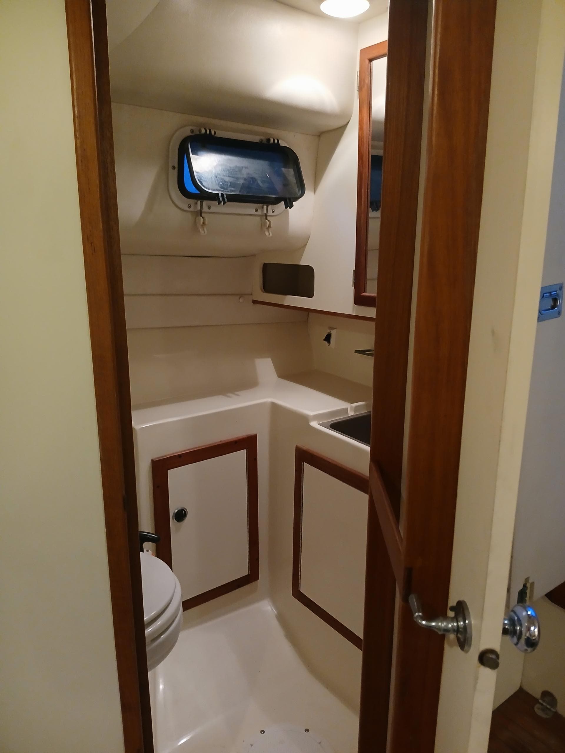 1995 Albin 28 Tournament Express boat bathroom with sink and toilet.