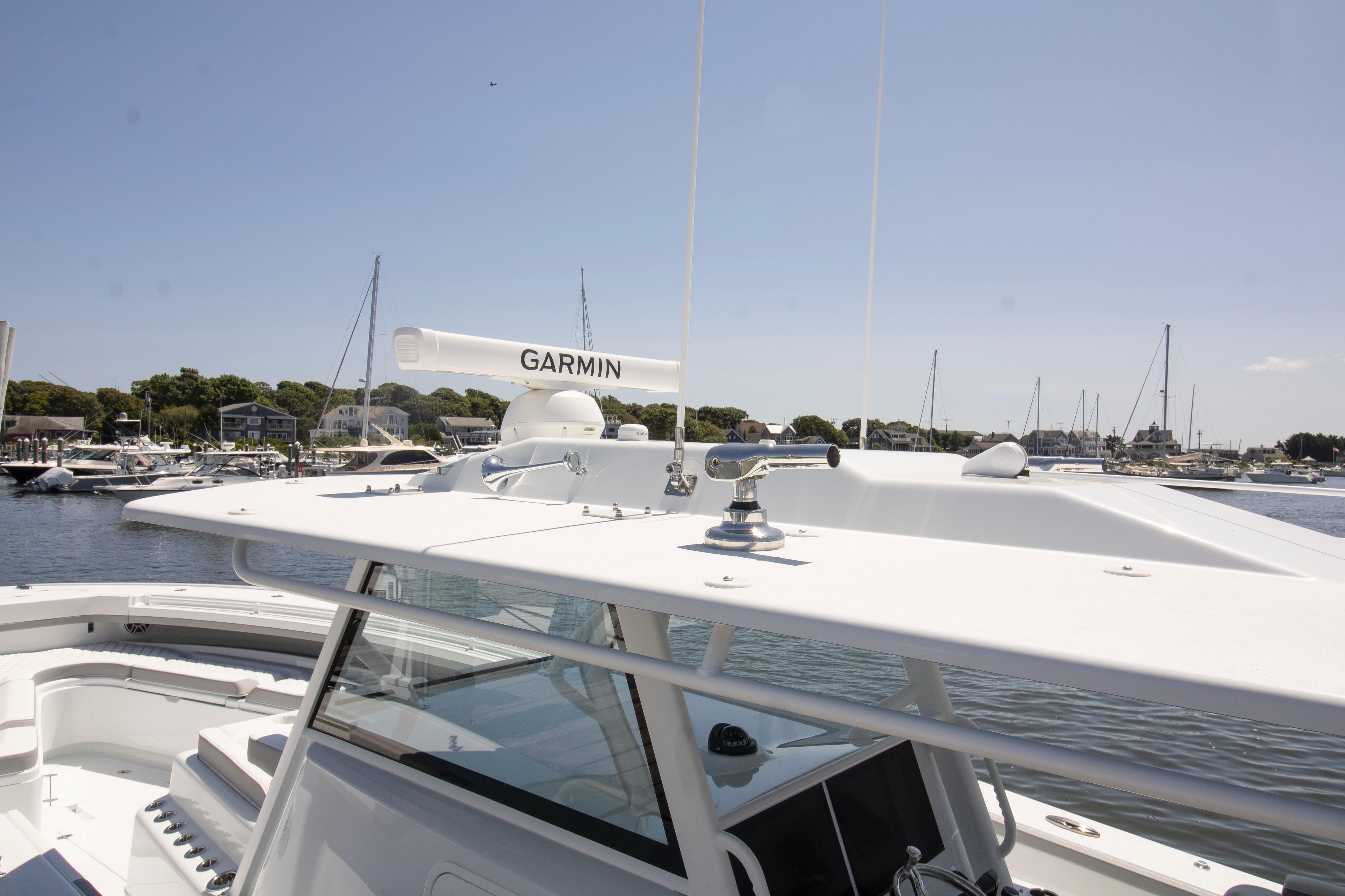 2026 Yellowfin 42 Offshore boat with Garmin radar, docked in a marina.