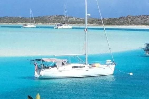 2008 Beneteau 43 sailboat anchored in turquoise waters.