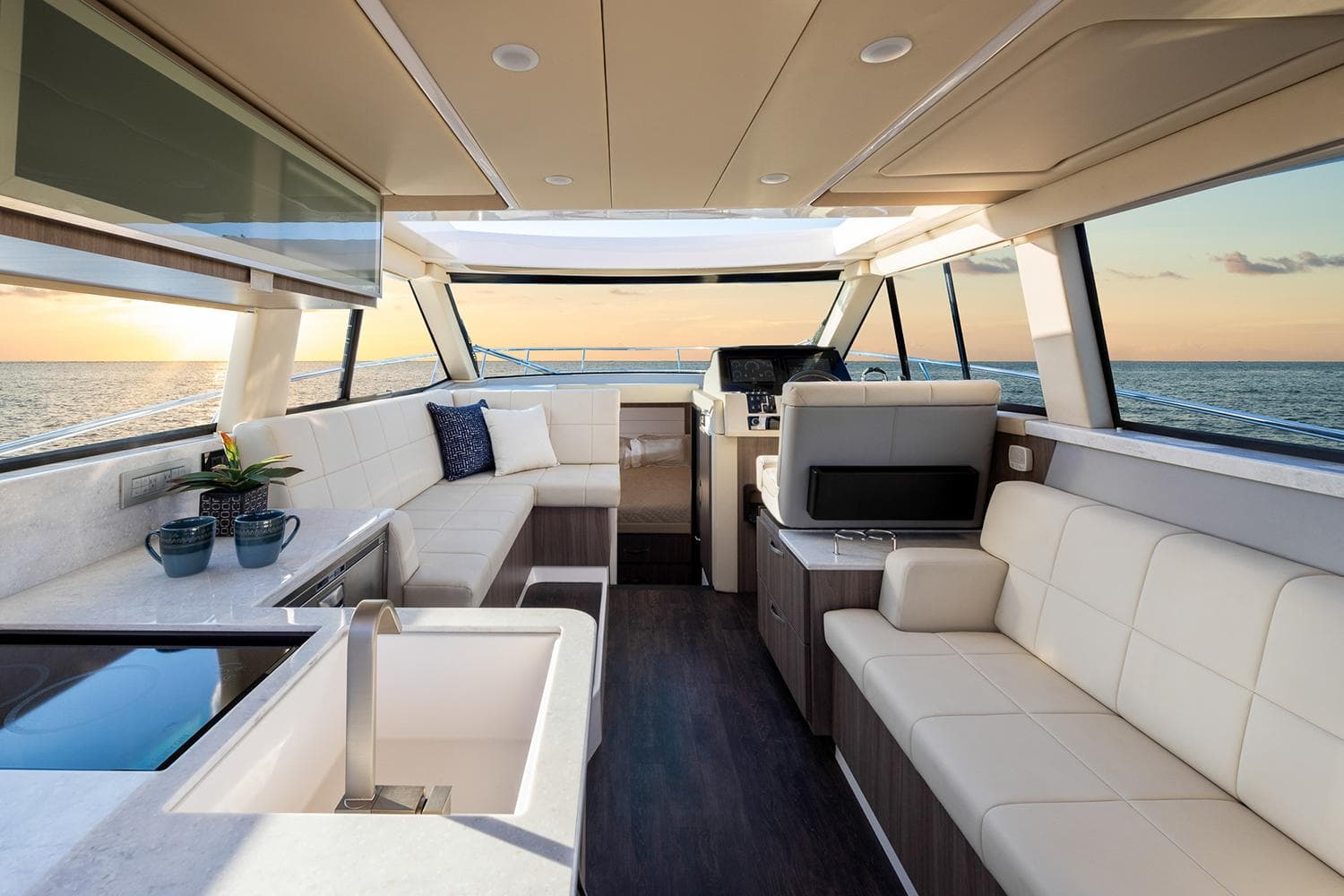 Manufacturer Provided Image: Luxurious interior of 2026 Regal 38 FXO yacht with modern seating and ocean view.
