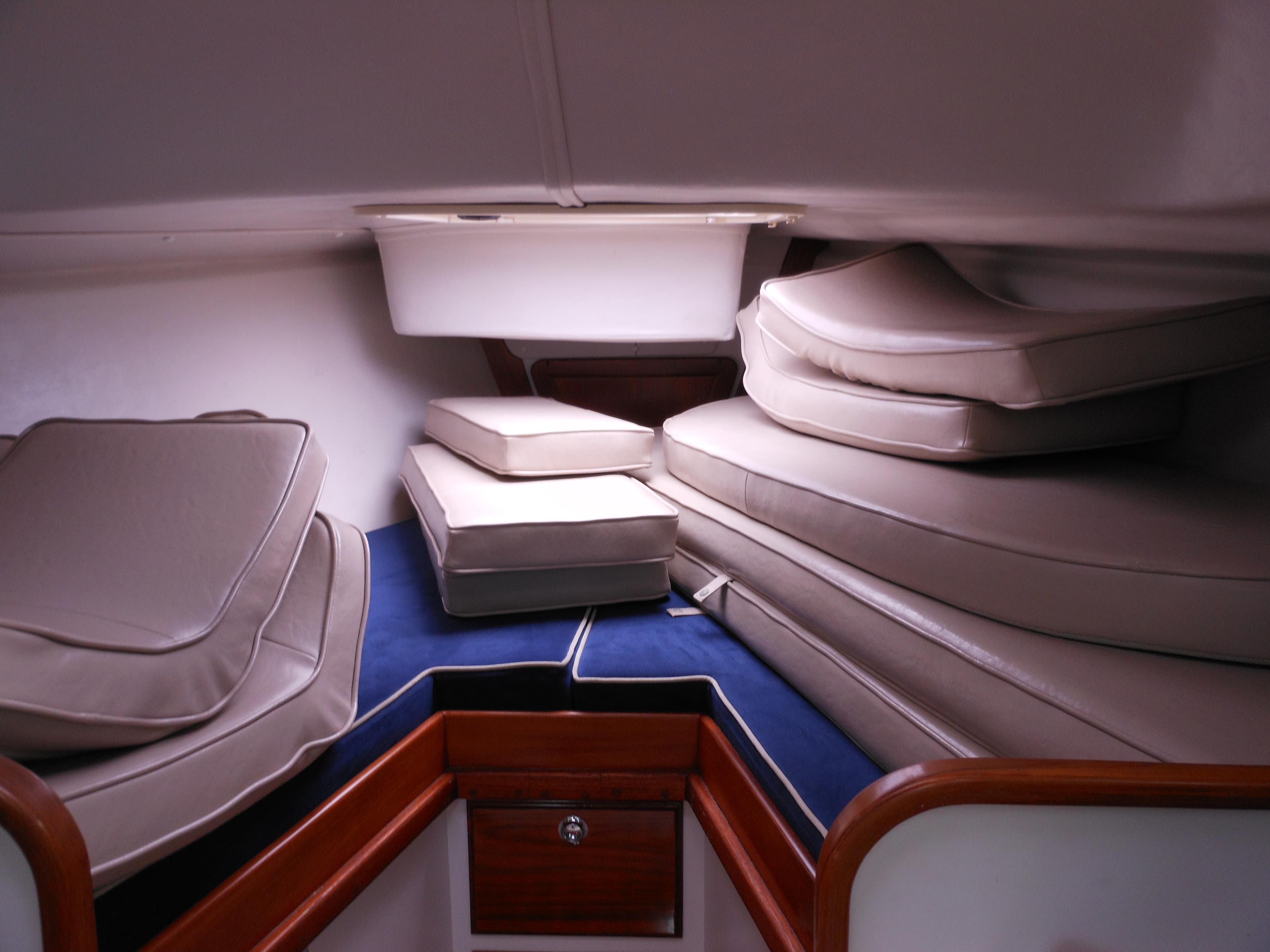 Interior cabin of 2009 Alerion Express 33 sailboat with stacked cushions.