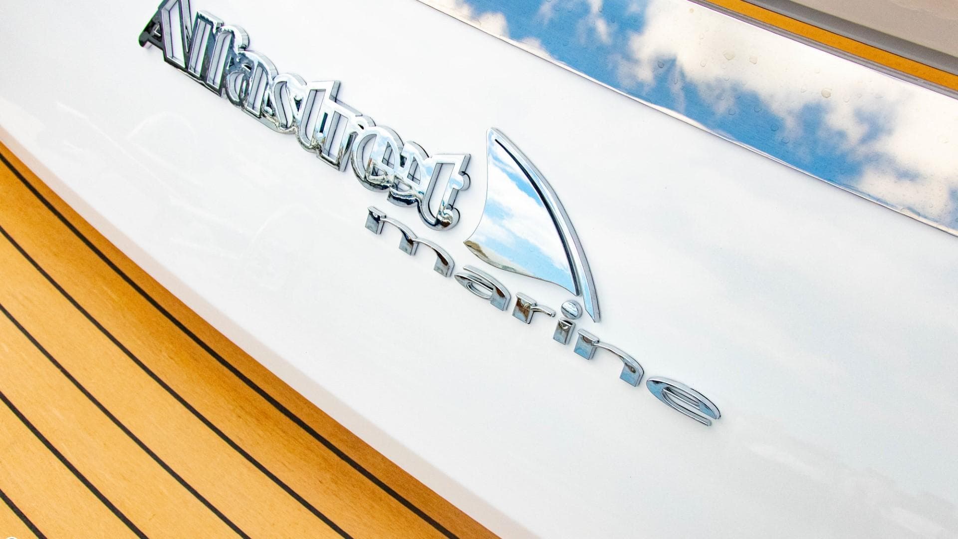 Alfastreet 21 Open 2023 model logo on white boat with wooden deck.