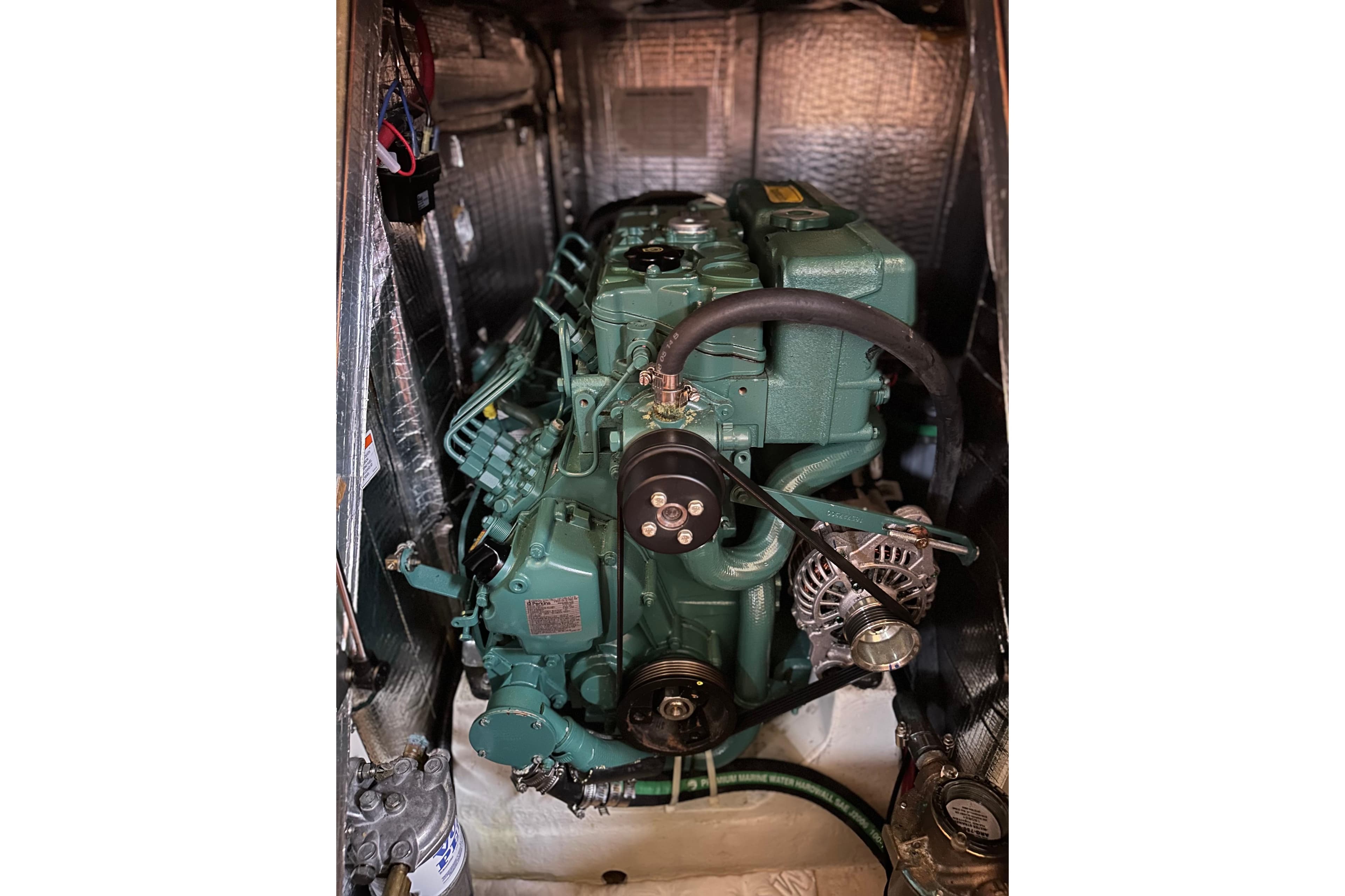 Engine compartment of a 2016 Tartan 4000 sailboat, showcasing a green marine engine.
