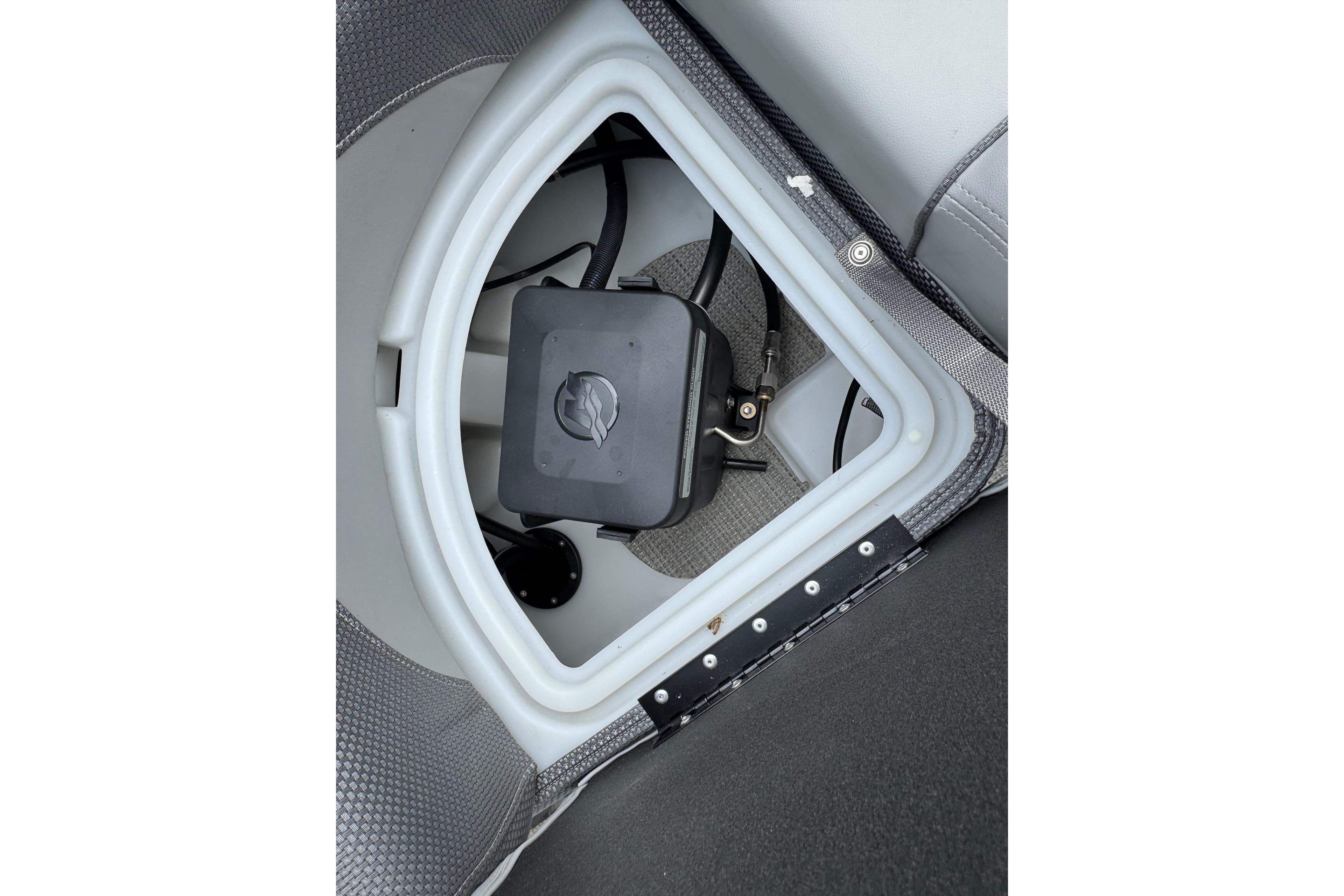 Storage compartment of 2024 Regency 230 DL3 boat, featuring a secure latch system.